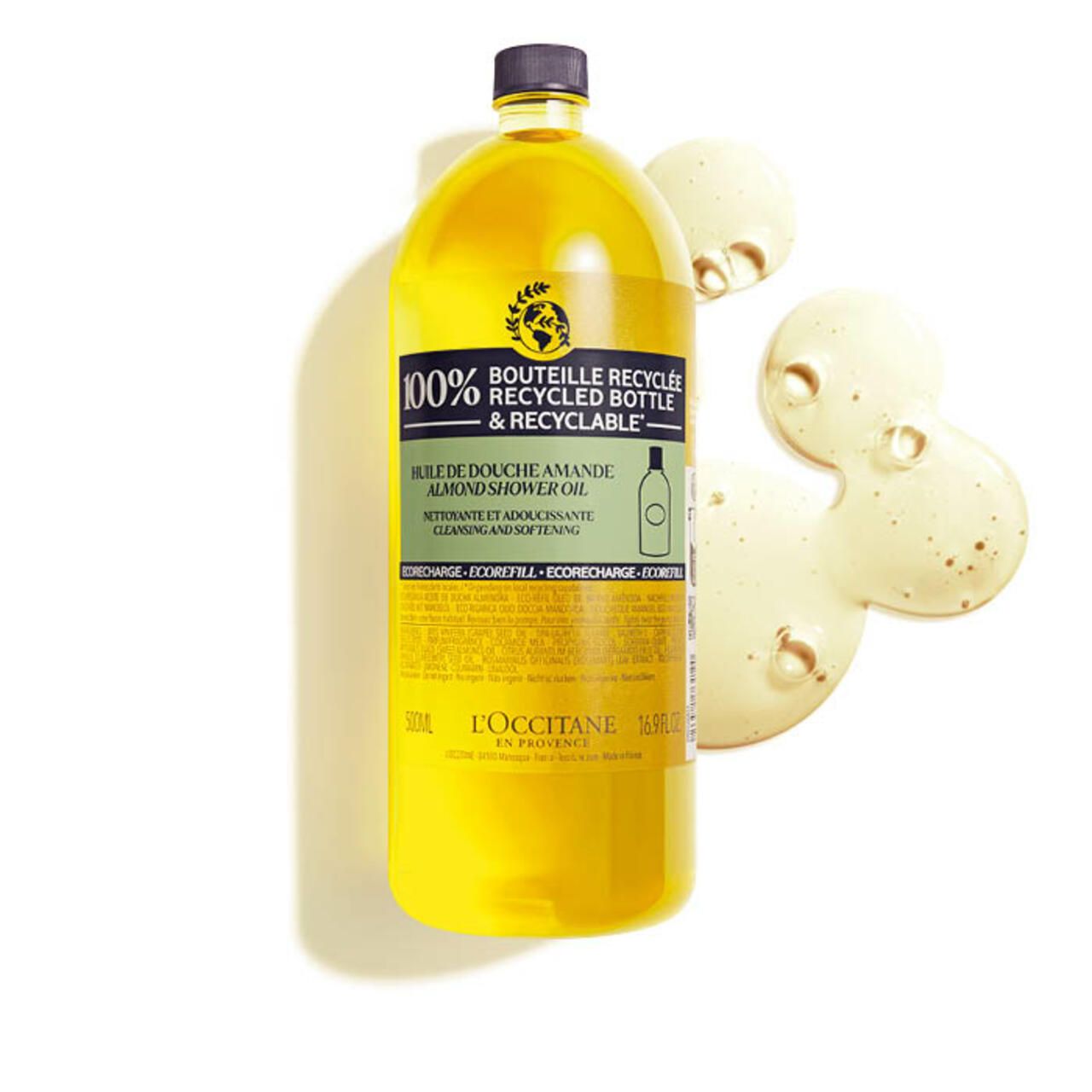 Gelbe Flasche mit Mandel Duschöl. Aufschrift: 100% recycelte Flasche. L'Occitane.