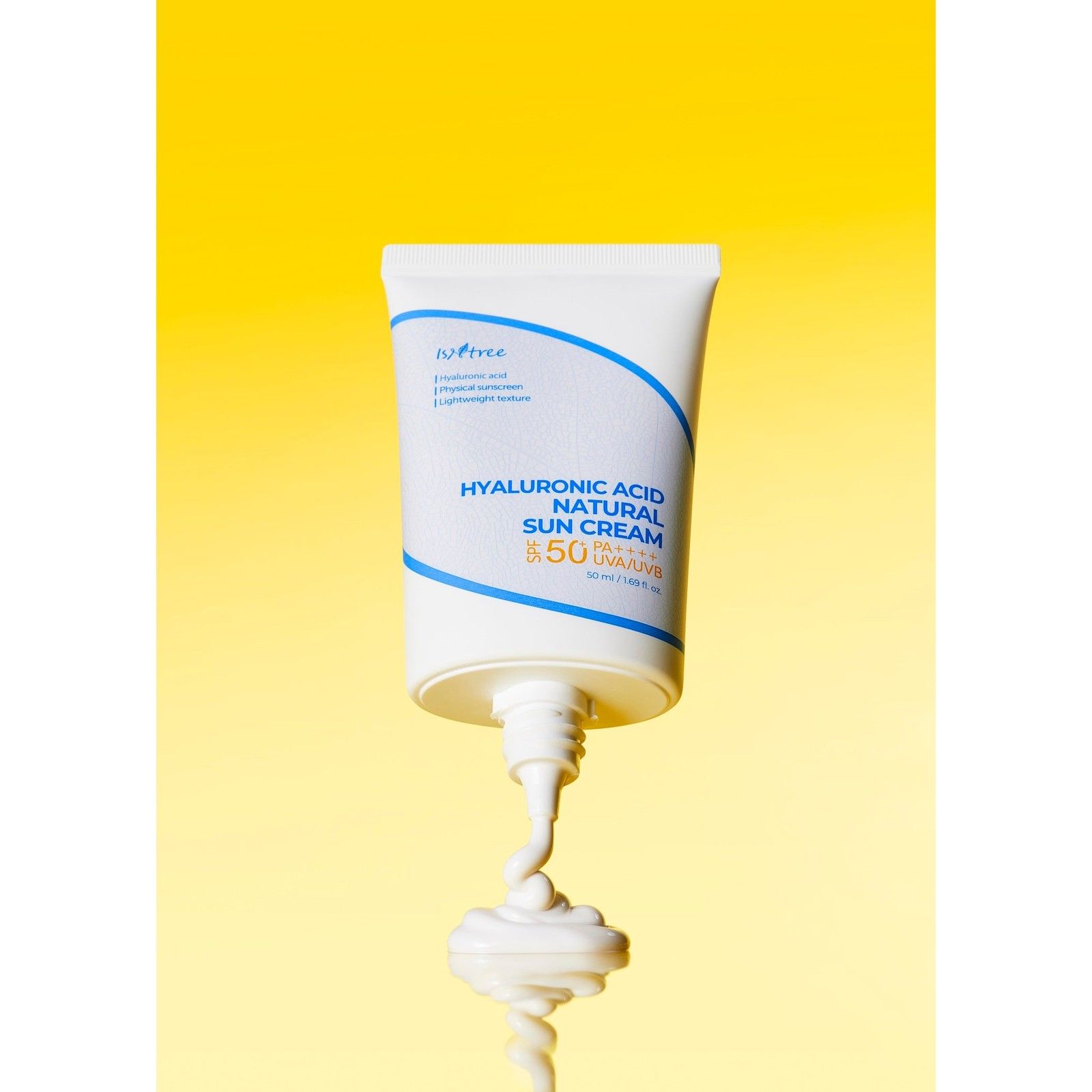 Isntree Hyaluronic Acid Natural Sun Cream SPF 50 wird aus einer Tube auf gelbem Hintergrund gedrückt.