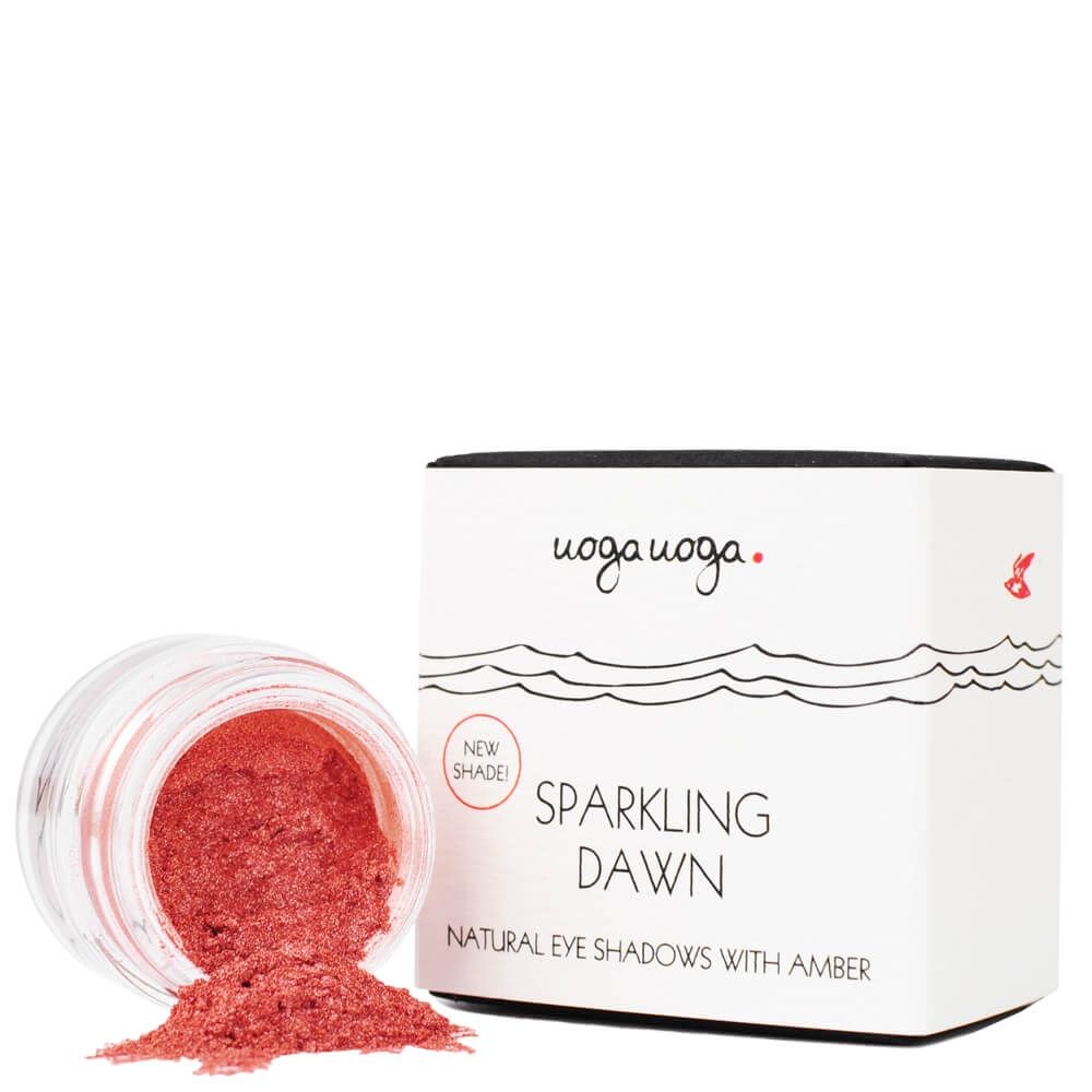 Eine geöffnete Dose Lidschatten mit rosa Inhalt, daneben eine Schachtel mit dem Schriftzug "Sparkling Dawn".