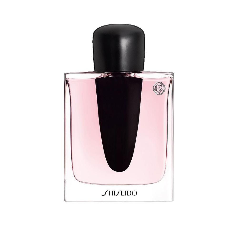 Parfümflakon mit schwarzem Verschluss und rosa Flüssigkeit. Aufschrift SHISEIDO.