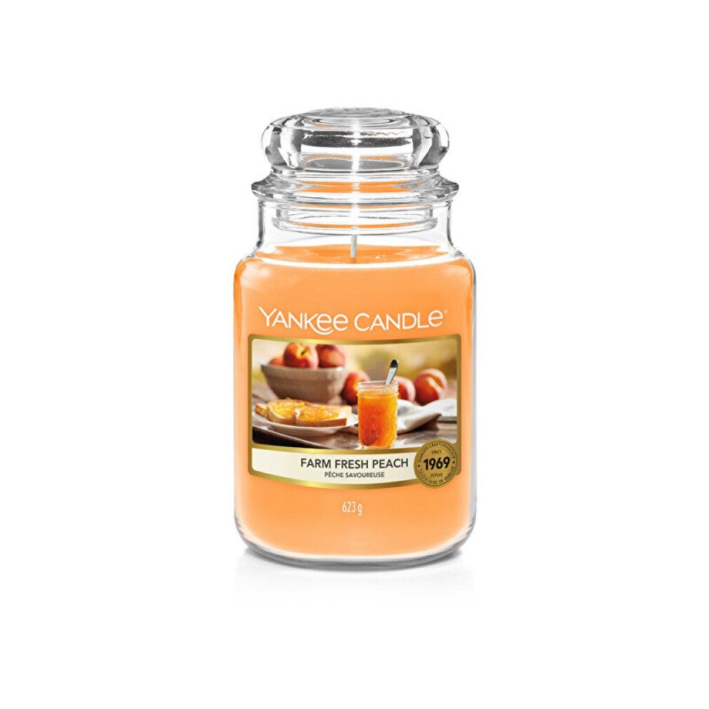Duftkerze im Glas mit Deckel. Etikett mit Pfirsich-Motiv und Schriftzug "Yankee Candle". Gewicht: 425g.