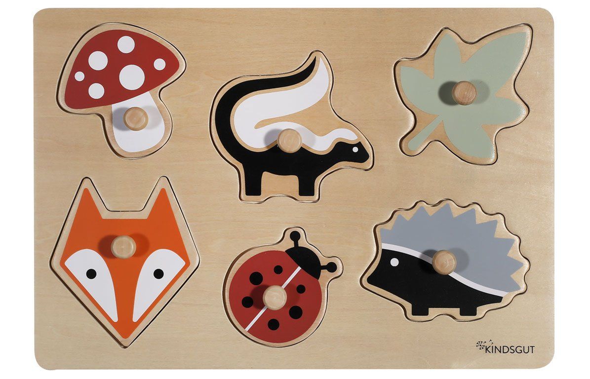Holzpuzzle mit Waldtieren. Sechs farbige Puzzleteile: Pilz, Stinktier, Blatt, Fuchs, Marienkäfer, Igel. Mit Knöpfen.