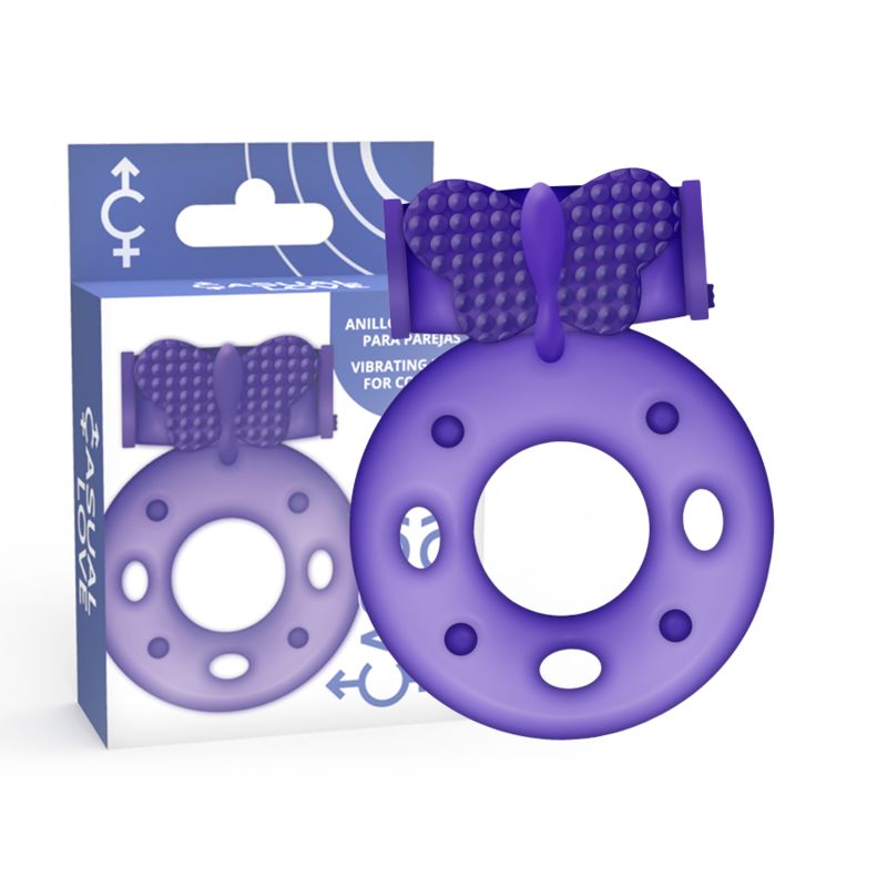 Lila Vibrationsring mit Klitorisstimulation und Verpackung. Ringförmig mit Noppen und Schmetterlingsform. Verpackung mit Text.