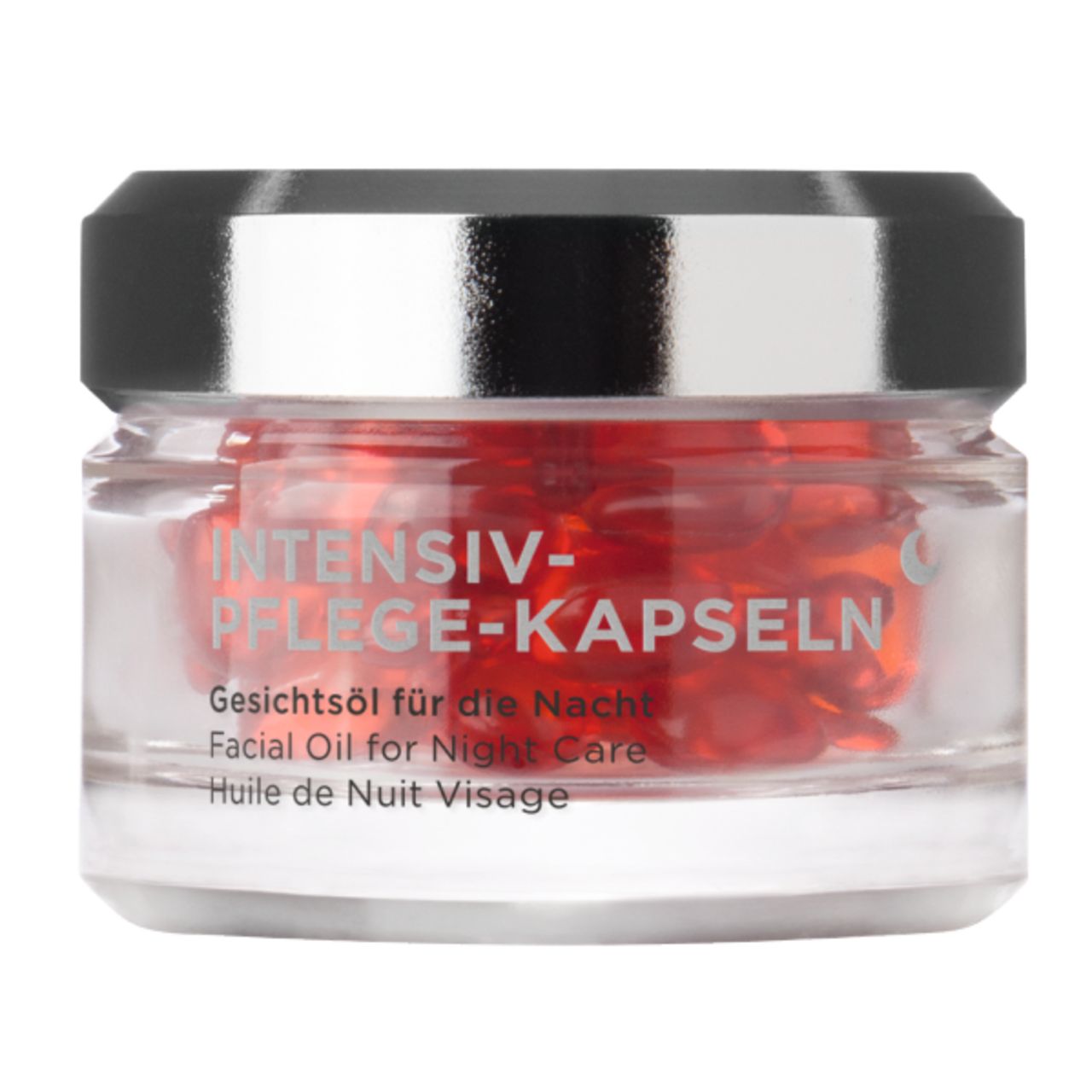 Glasbehälter mit roten Kapseln. Aufschrift: INTENSIV-PFLEGE-KAPSELN. Gesichtsol für die Nacht.