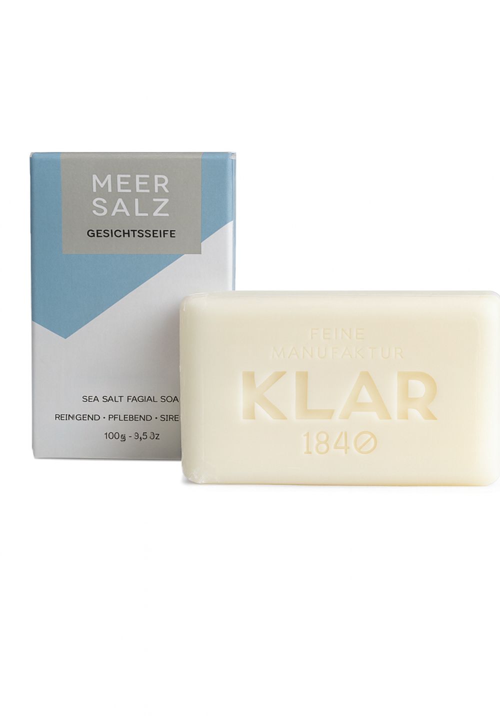 Seifenstück und Verpackung. Seife mit Prägung "KLAR". Verpackung mit "MEER SALZ GESICHTSSEIFE" und Text.