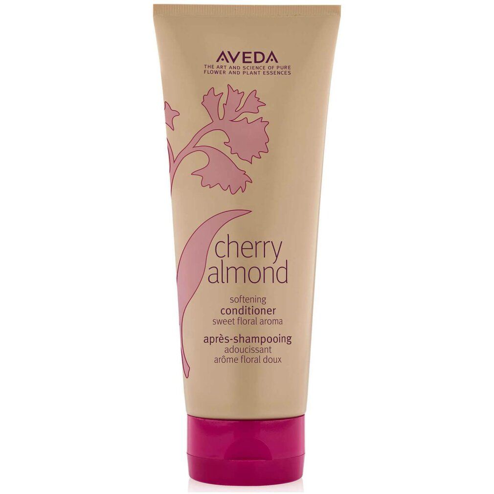 Beige Tube mit rosa Verschluss. Aufschrift: Aveda, Cherry Almond, Softening Conditioner. Florales Design.