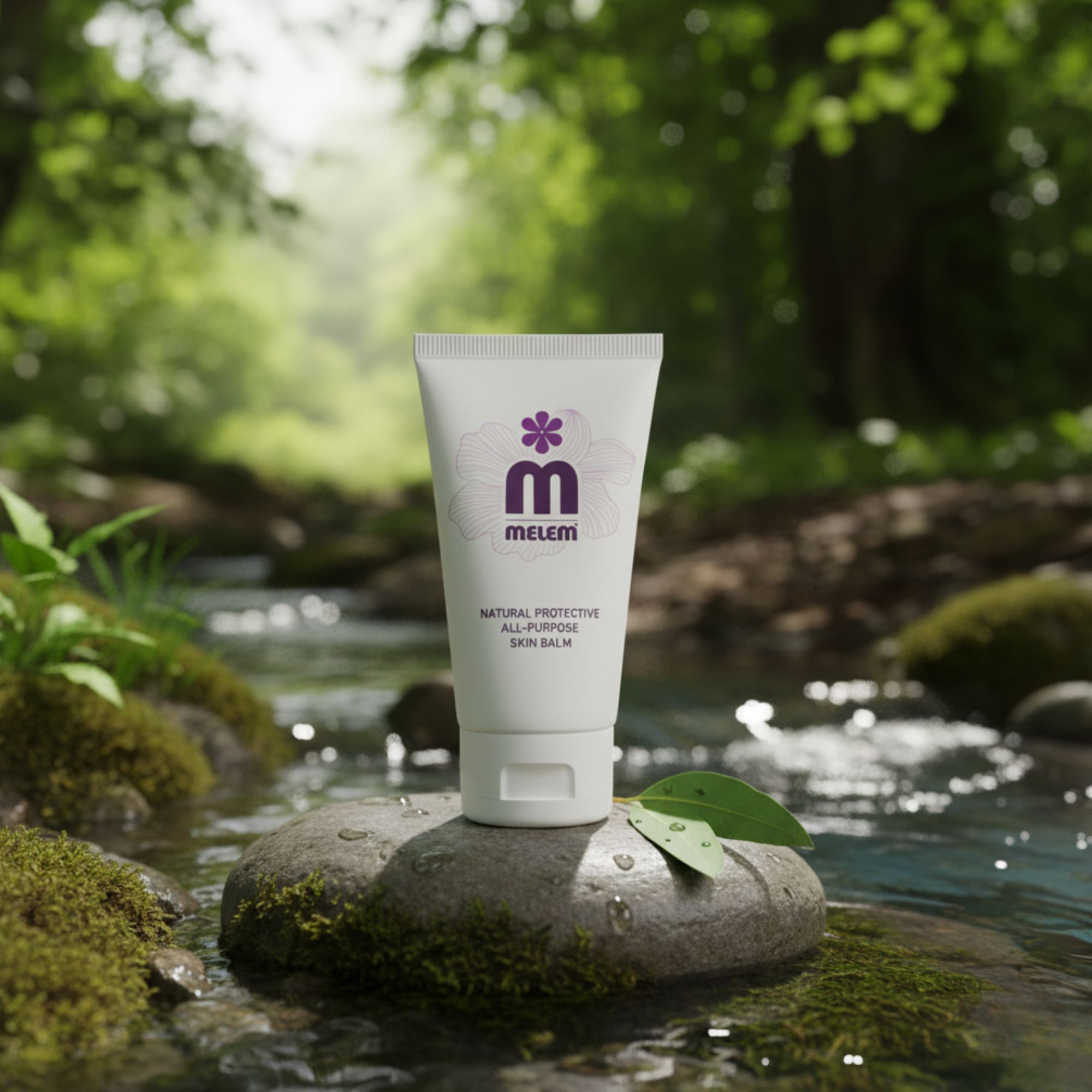 Weiße Tube mit lila Logo und Text: Melem, Natural Protective All-Purpose Skin Balm. Auf Stein in Fluss platziert.
