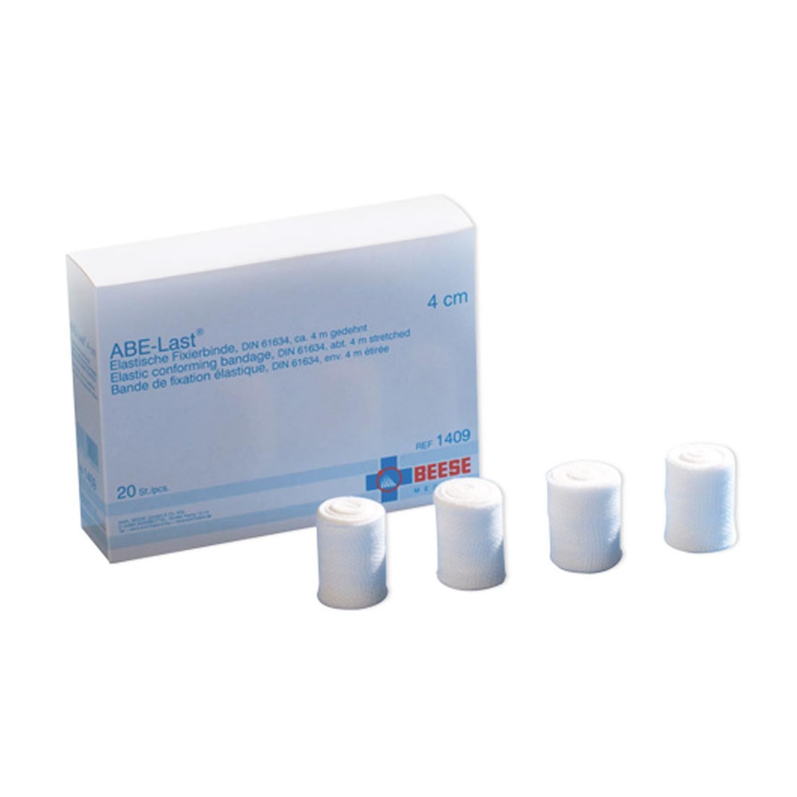 Weiße ABE Last® Fixierbinden in einer Box. 4 Rollen liegen daneben. Aufdruck: 4 cm.