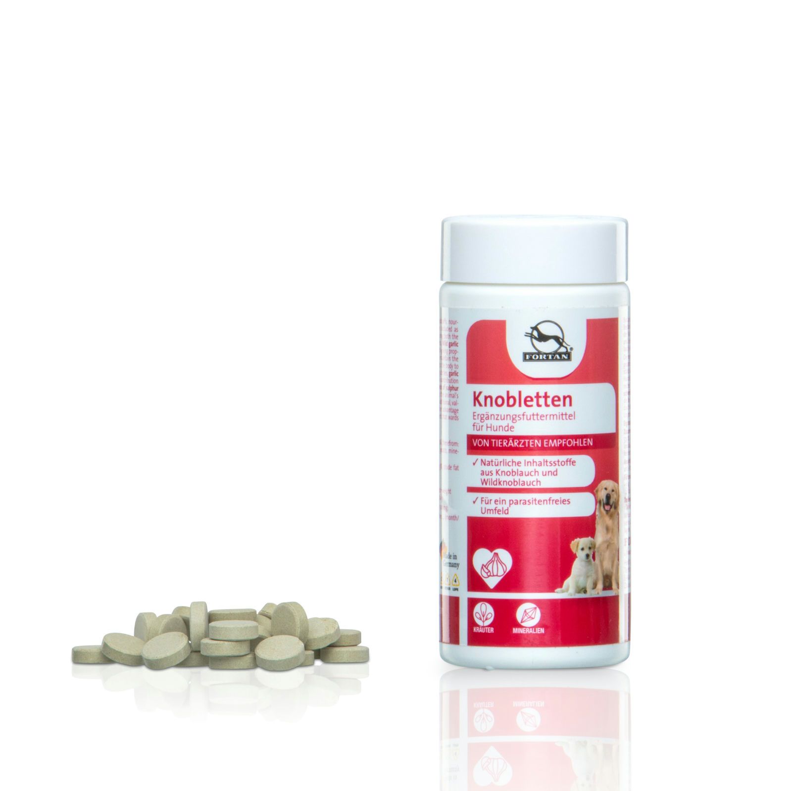 Weiße Dose mit rotem Etikett und Tabletten daneben. Aufschrift: FORTAN Knobletten. Abbildung von Hunden.