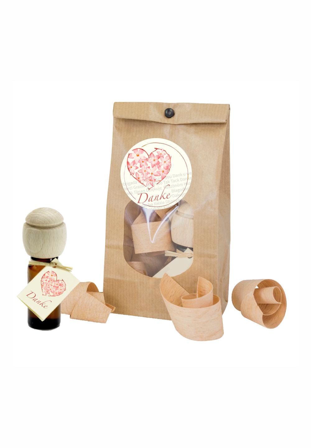Geschenkset mit Parfümöl. Braune Glasflasche mit Holzdeckel und Anhänger. Papiertüte mit Sichtfenster und Holzspänen.