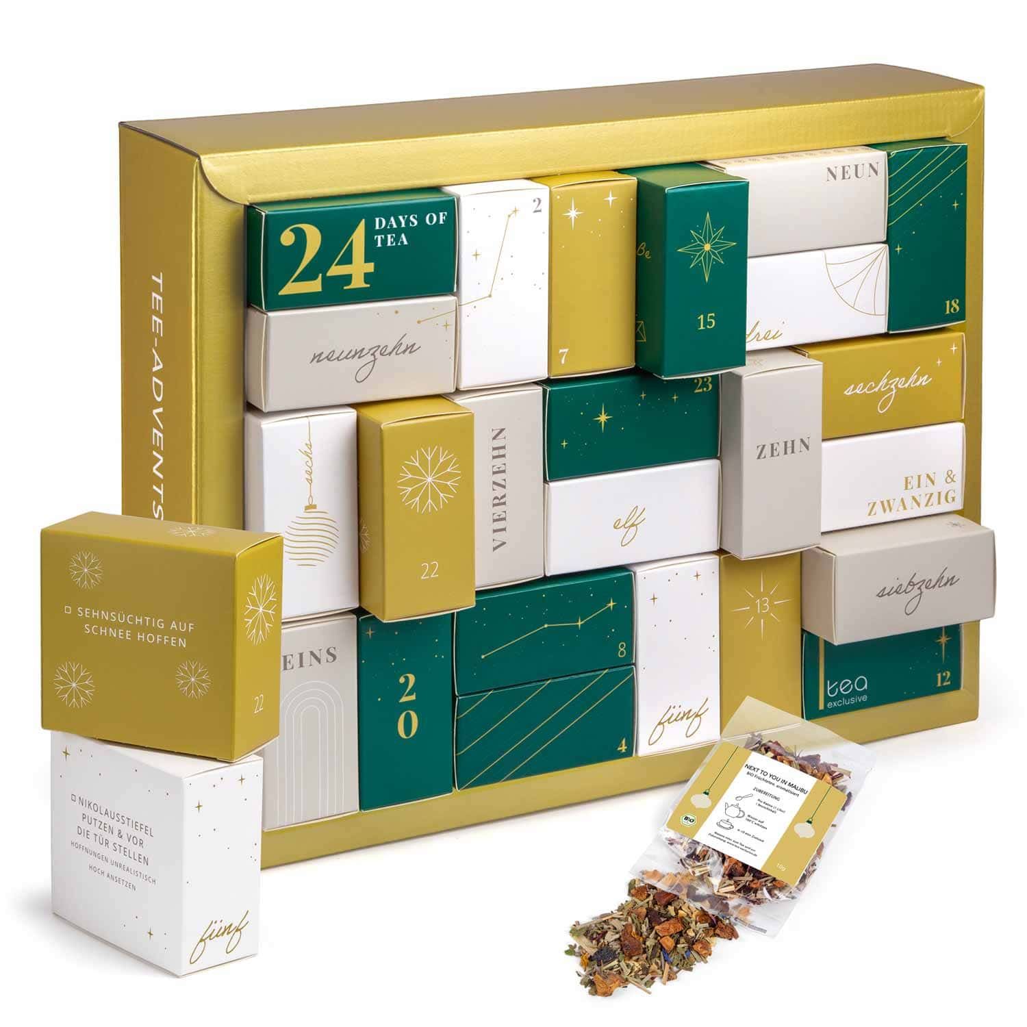 Tee Adventskalender mit 24 kleinen Schachteln, goldener Rahmen, einige Schachteln geöffnet.