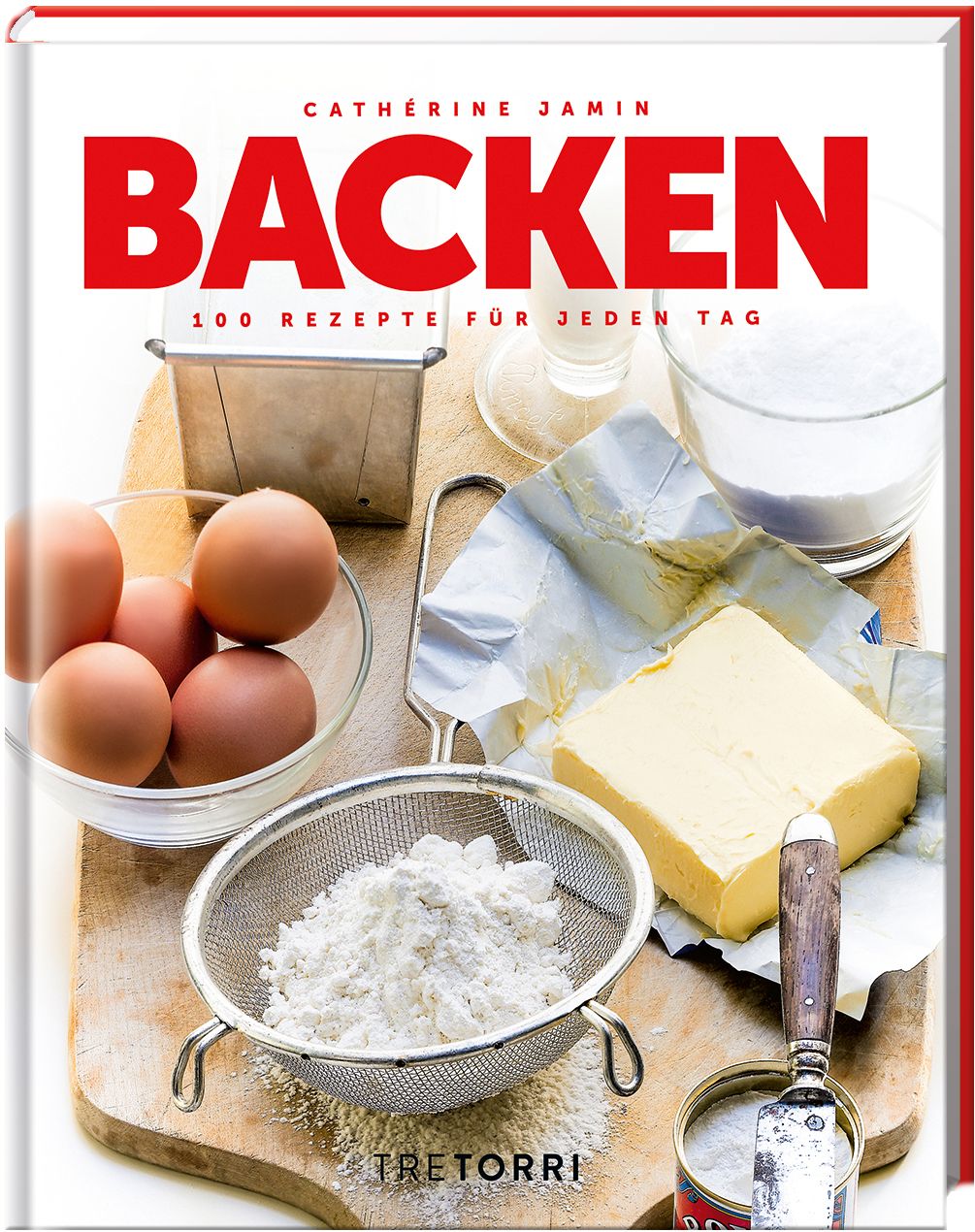 Buch mit dem Titel "BACKEN". Auf dem Cover stehen der Name der Autorin und der Untertitel "100 Rezepte für jeden Tag". Auf einem Holzbrett liegen Zutaten.