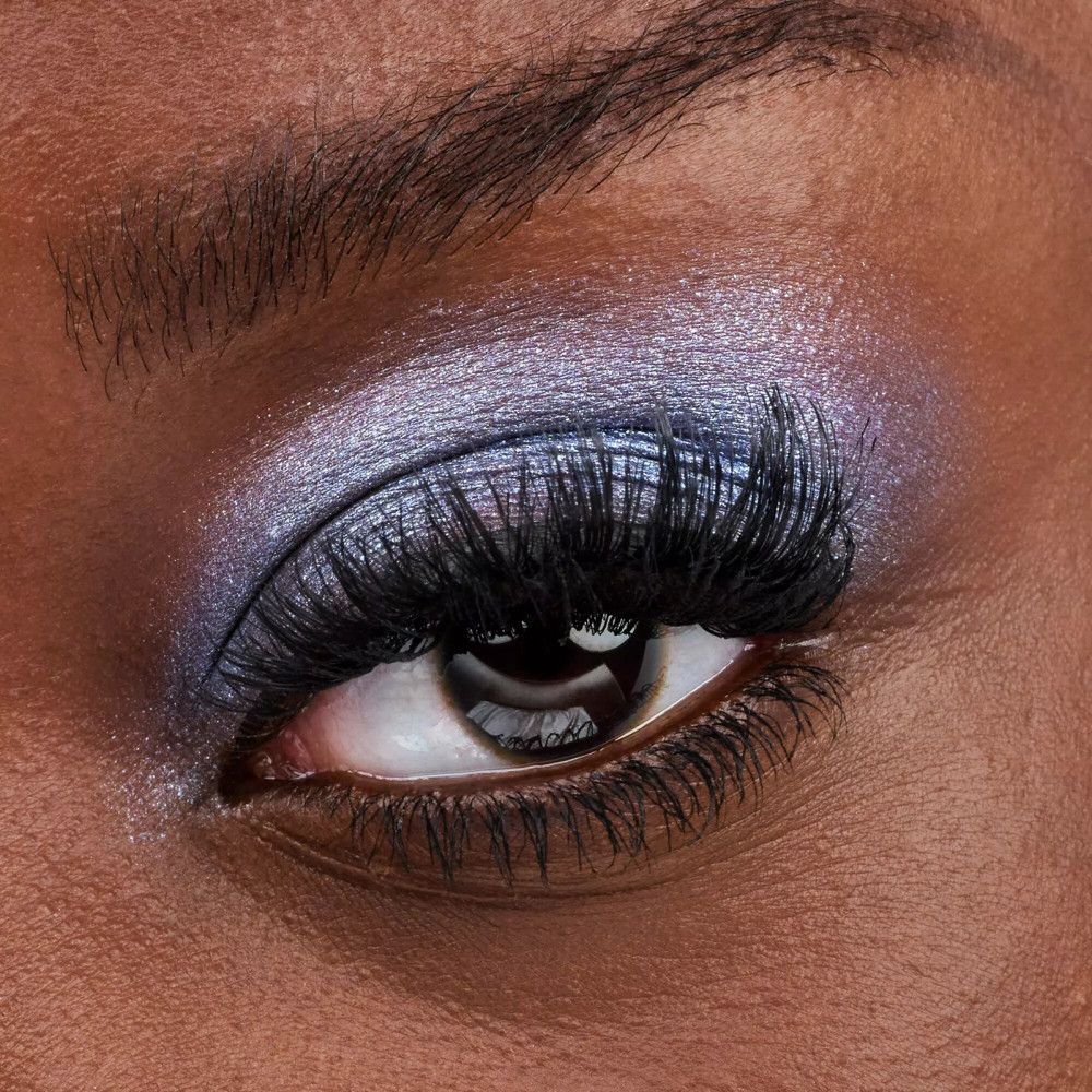 Nahaufnahme eines Auges mit falschen Wimpern und Lidschatten.