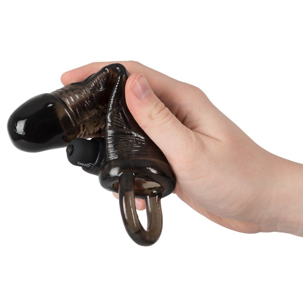 Schwarzes Verlängerungsstück in einer Hand gehalten. Ring und Aufsatz sichtbar. Geformte Oberfläche.