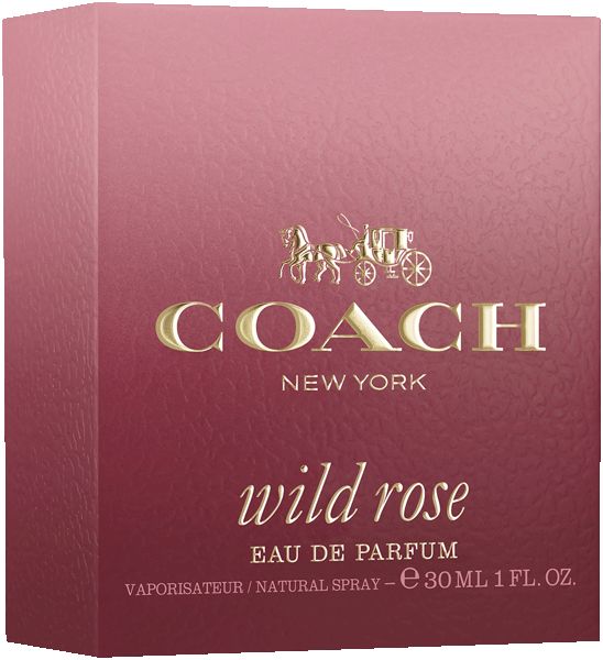 Eine Frau hält einen Flakon. Der Flakon ist rund, rosa-rot und hat einen goldenen Verschluss. Sie trägt eine Jacke.