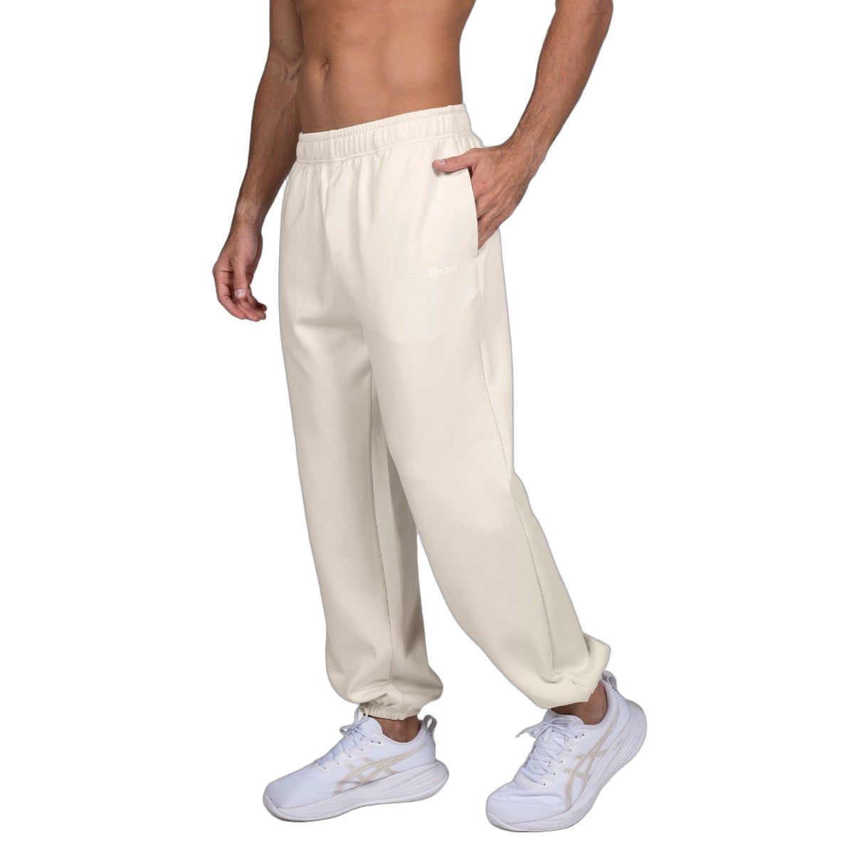 Herren-Jogginghose in Beige, seitliche Ansicht, Oversized-Passform, elastischer Bund.