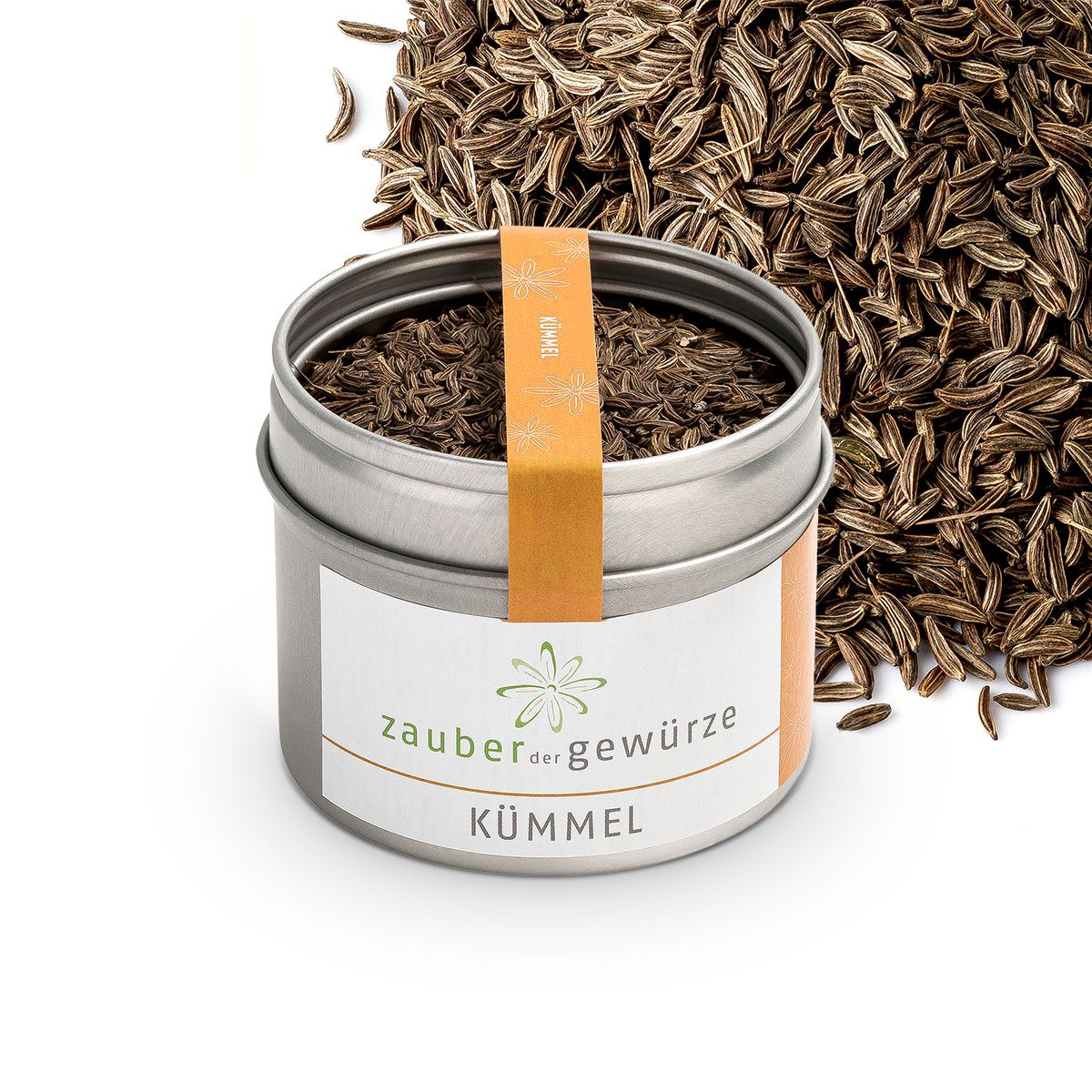 Metallbehälter mit Kümmel, daneben Kümmelsamen. Etikett "Zauber der Gewürze Kümmel". Orangefarbener Streifen mit "Kümmel".