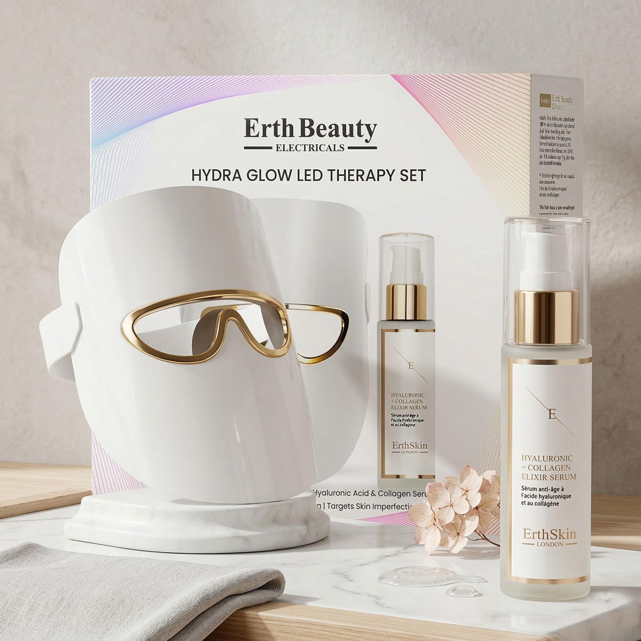 Erth Skin London Hydra Glow LED Therapy Set mit Gesichtsmaske und zwei Seren, auf einem Tisch arrangiert.