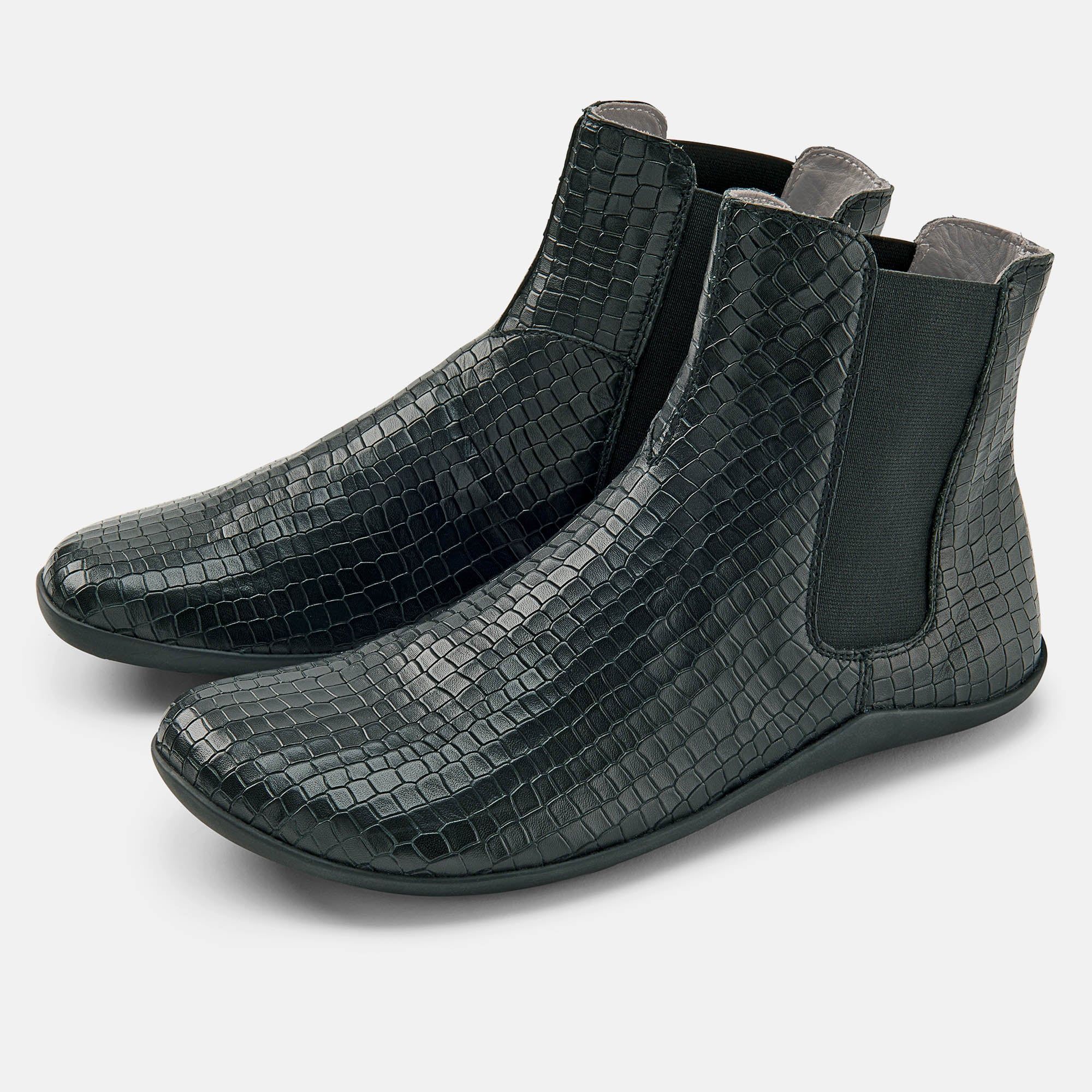 Schwarze Stiefelette mit Krokodil-Optik. Elastischer Einsatz an der Seite. Flache Sohle.