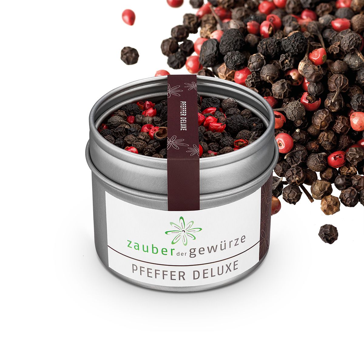 Geöffnete Dose mit Pfefferkörnern. Aufschrift: Zauber der Gewürze Pfeffer deluxe. Pfefferkörner daneben.