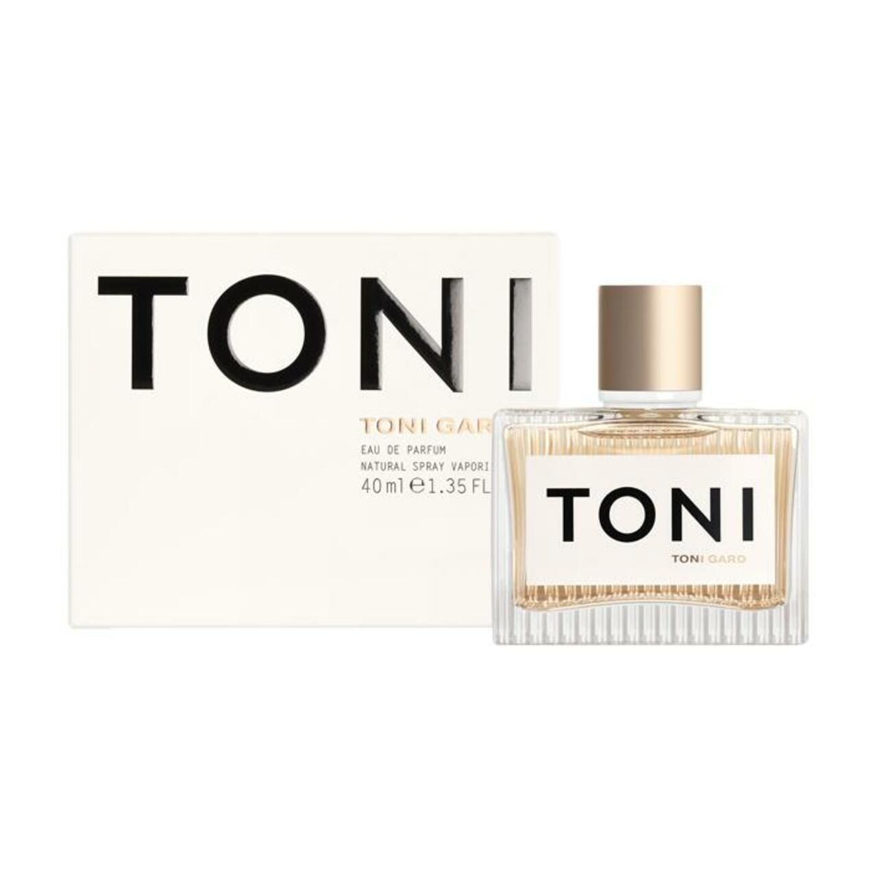 Parfümflakon und Schachtel. Flakon rechteckig, transparent, mit goldfarbenem Verschluss. Schachtel weiß mit schwarzem Schriftzug.