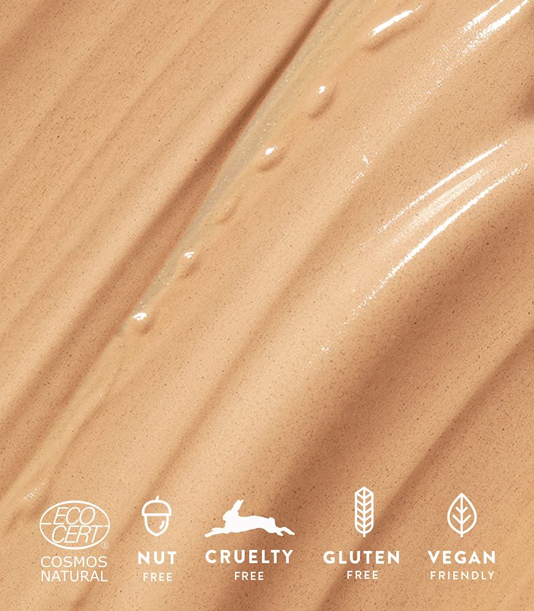 Nahaufnahme von Creme mit Logos: Cosmos Natural, Nut Free, Cruelty Free, Gluten Free, Vegan Friendly.