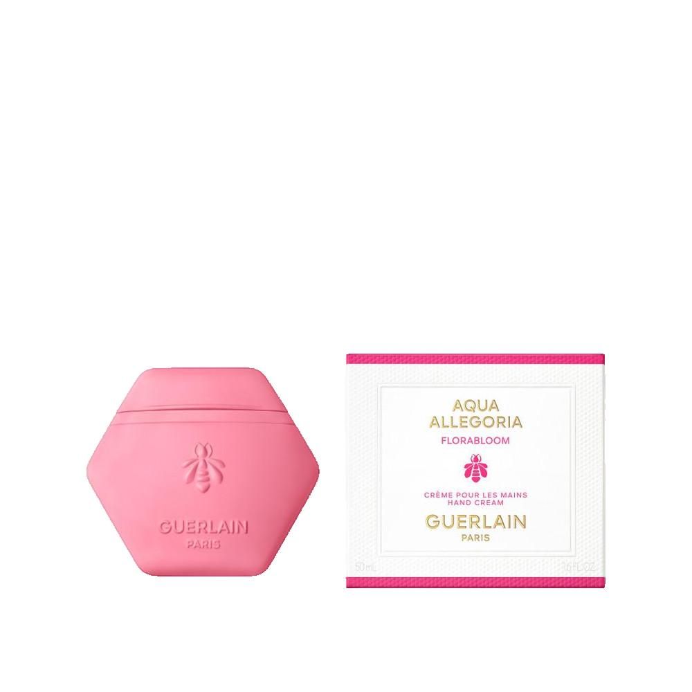 Rosa Handcreme-Behälter in sechseckiger Form mit Bienen-Emblem und Schriftzug. Daneben eine weiße Schachtel mit Text.