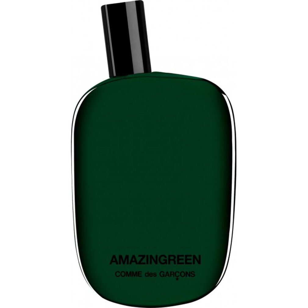 Grüne Flasche mit schwarzem Verschluss. Aufschrift: AMAZINGREEN, COMME des GARÇONS. Abgerundete Form.