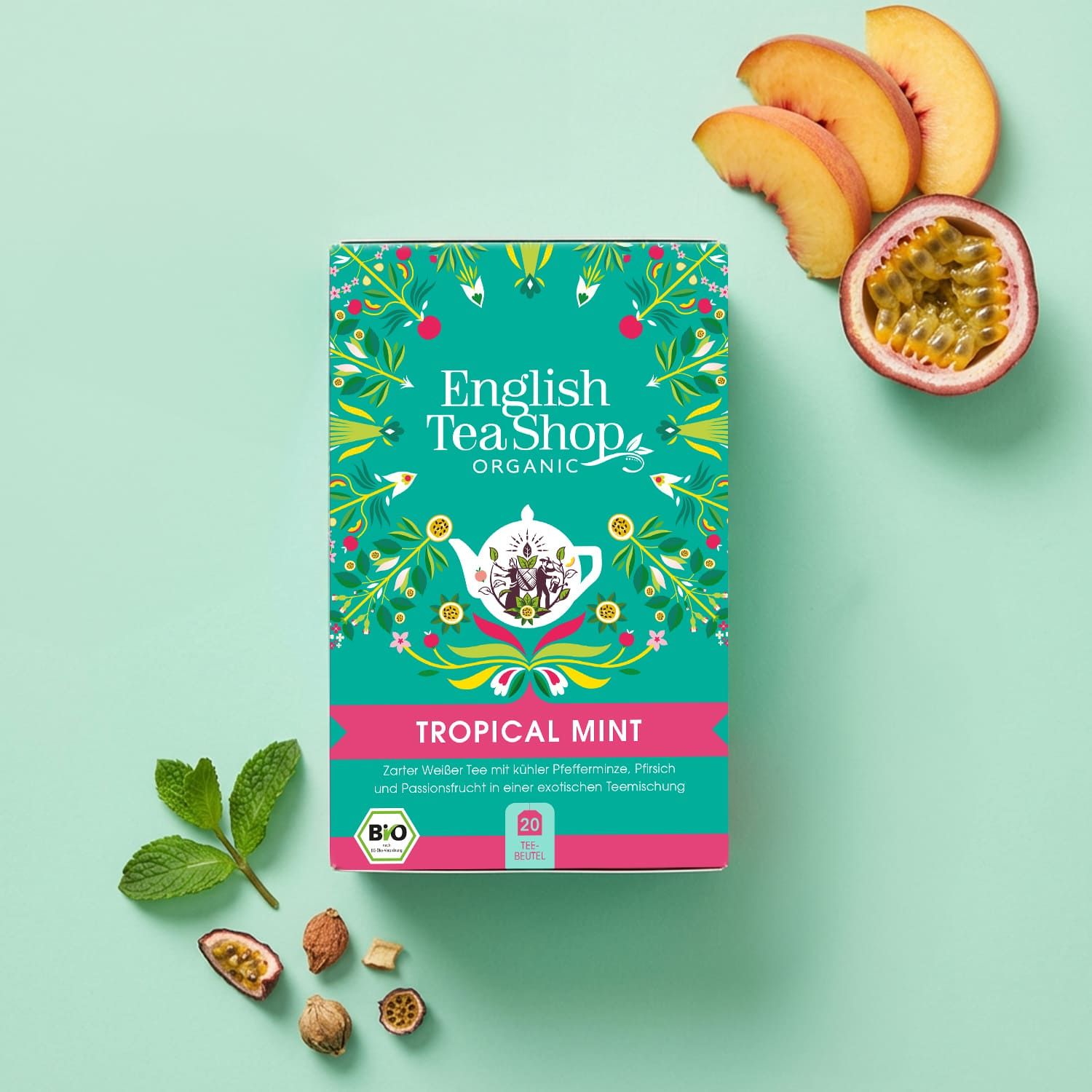 Grüne Teebox mit "English Tea Shop Organic" und "Tropical Mint". Pfirsich, Passionsfrucht und Minze daneben. Bio-Siegel. 20 Beutel.