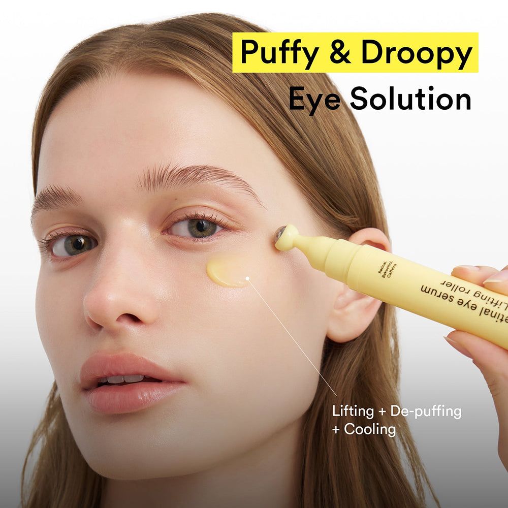 Frau mit ABIB Retinal Eye Serum Lifting Roller am Auge. Gelbes Serum mit kühlendem Roller.