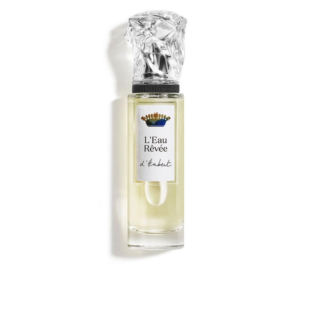 Flakon mit transparentem Glas, silbernem Verschluss und Etikett mit Schriftzug L'Eau Rêvée d'Hubert. Flüssigkeit hellgelb.