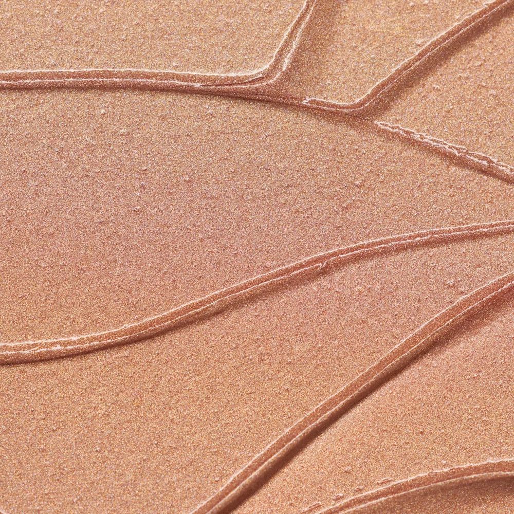 Nahaufnahme von Highlighter-Strichen. Goldfarben, glänzend. Textur sichtbar.