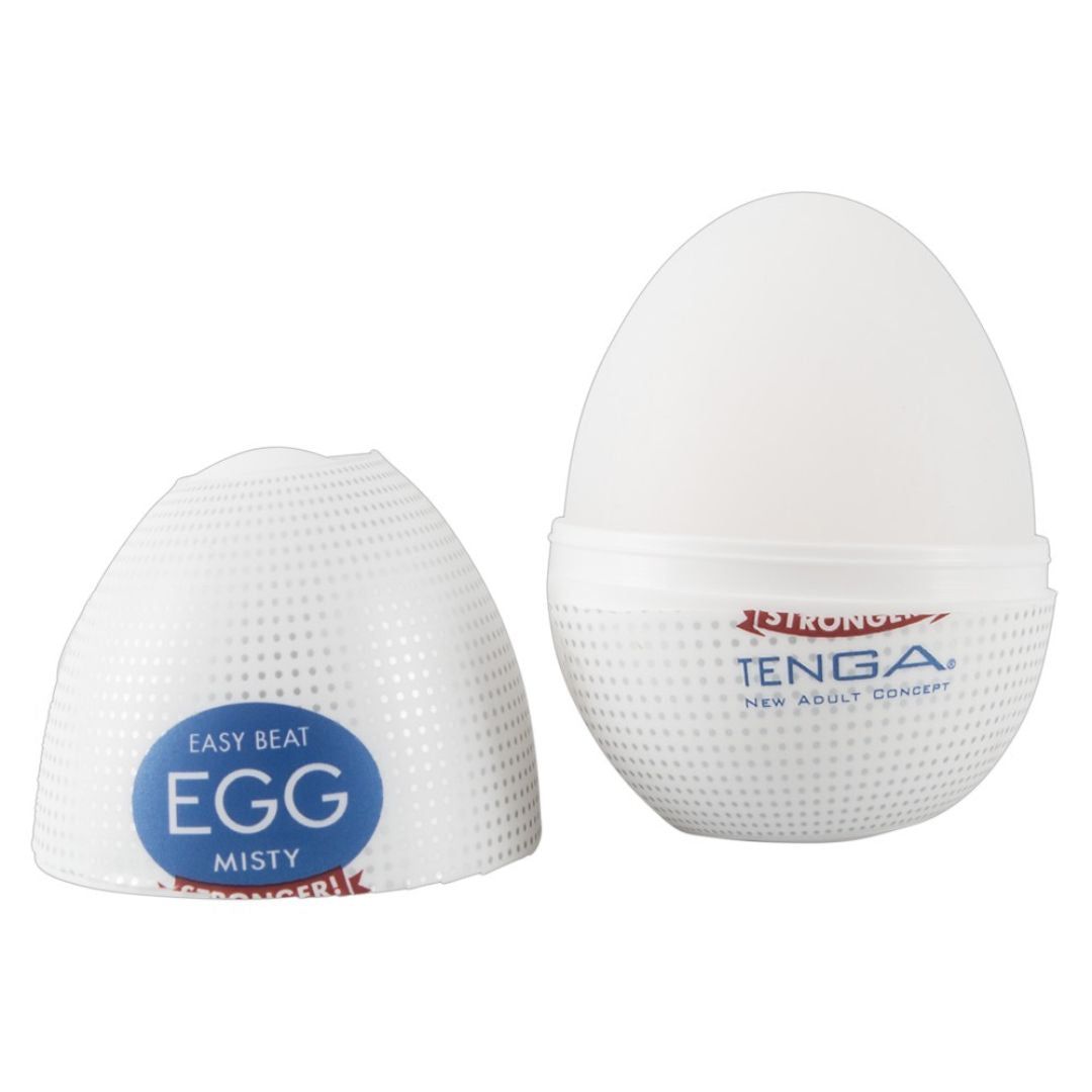Weißes, eiförmiges Produkt, teilweise geöffnet. Auf der Verpackung steht "TENGA" und "EGG MISTY".