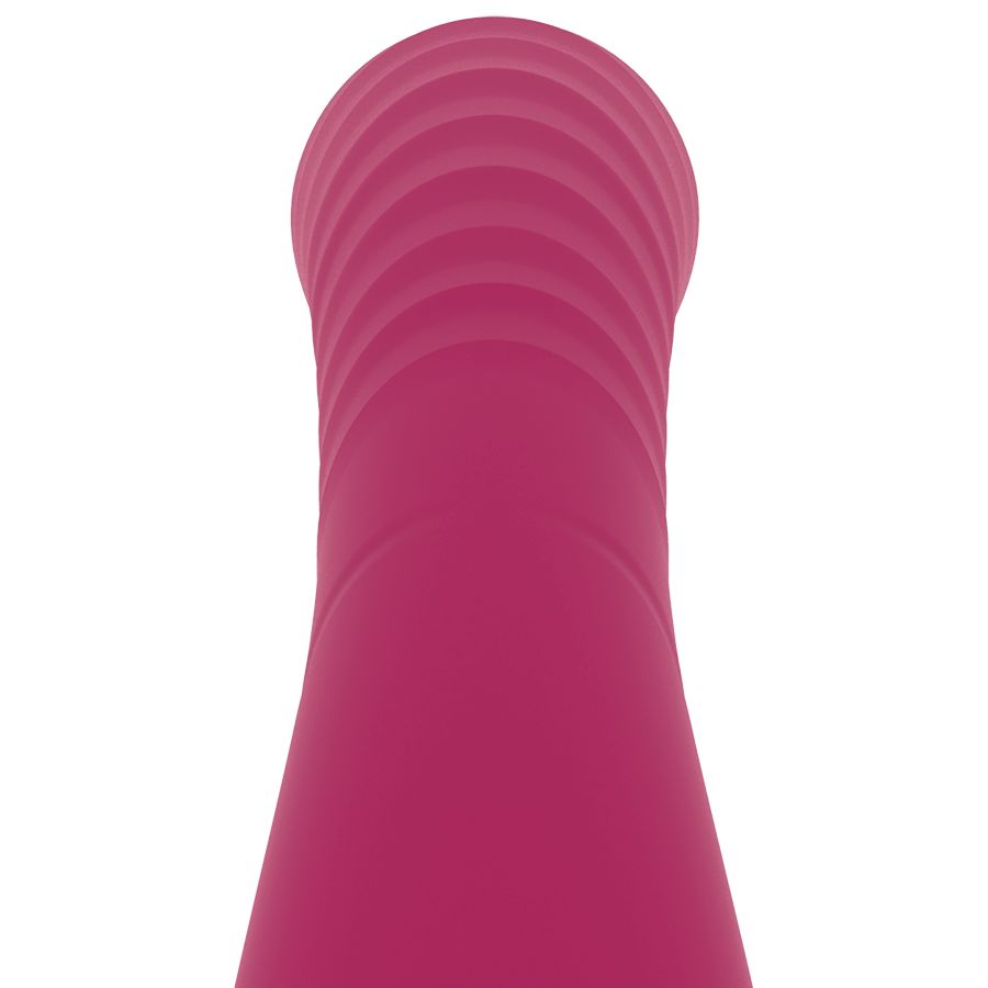 Nahaufnahme der Spitze eines pinkfarbenen Vibrators. Geriffelte Textur.