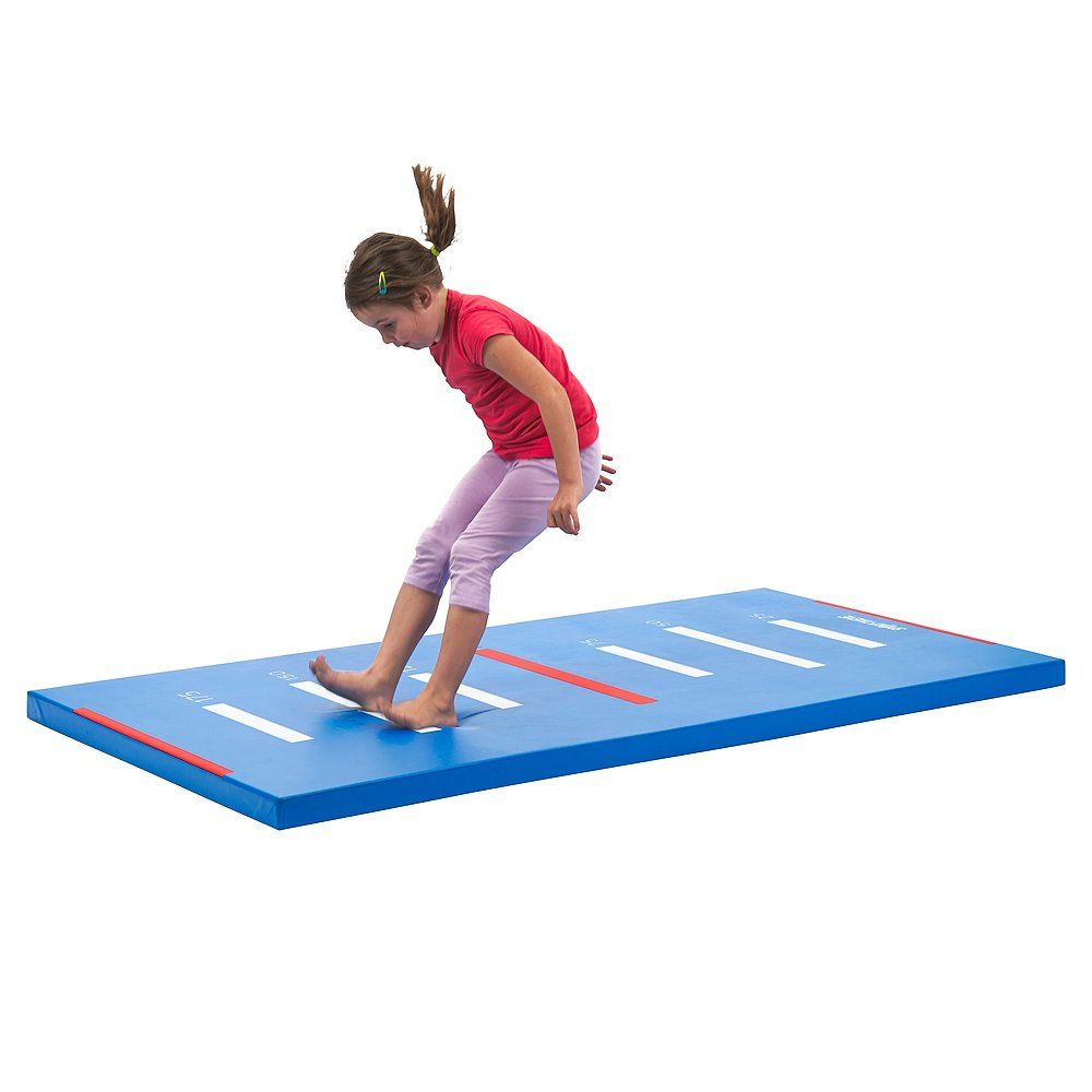 Blaues Turnmatte mit weißen Markierungen. Ein Mädchen springt darauf. Rote und weiße Streifen an den Rändern.