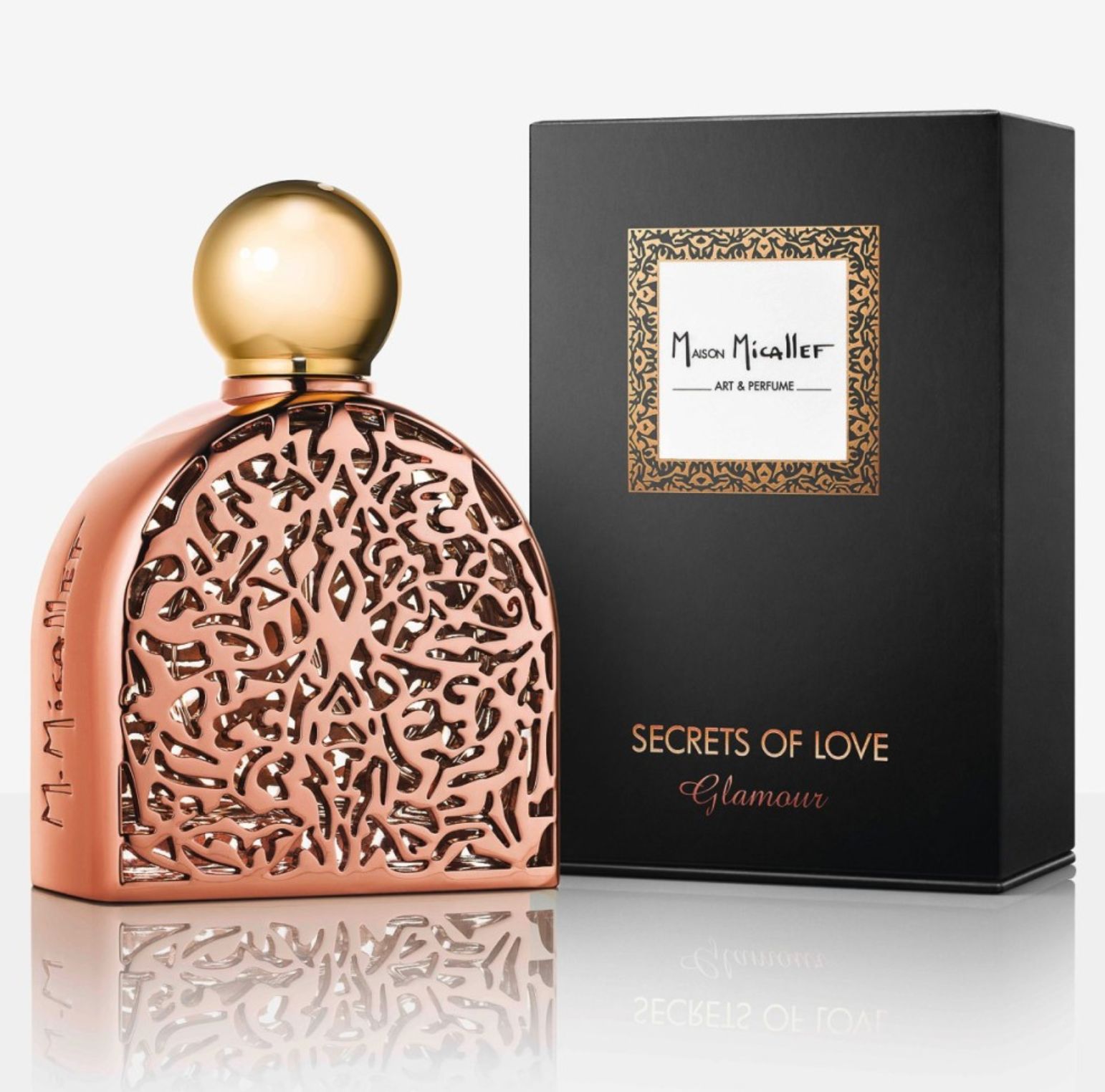 Kupferfarbener Flakon mit goldenem Deckel und schwarzer Schachtel. Aufschrift: M. Micallef, Secrets of Love Glamour.