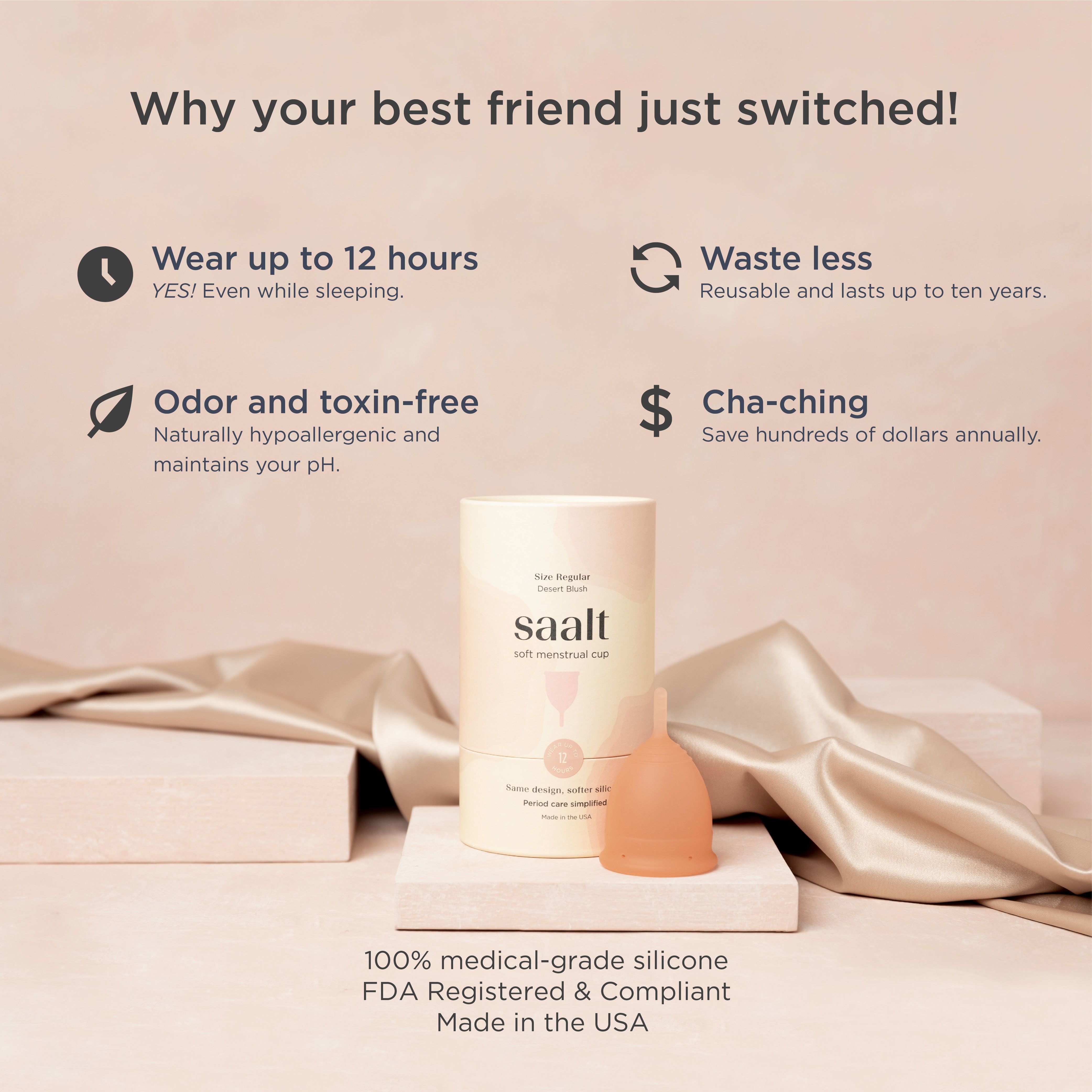 Saalt Menstruationstasse und Verpackung. Beschriftung: Saalt, 100% medizinisches Silikon, FDA-registriert. Auf Seide drapiert.