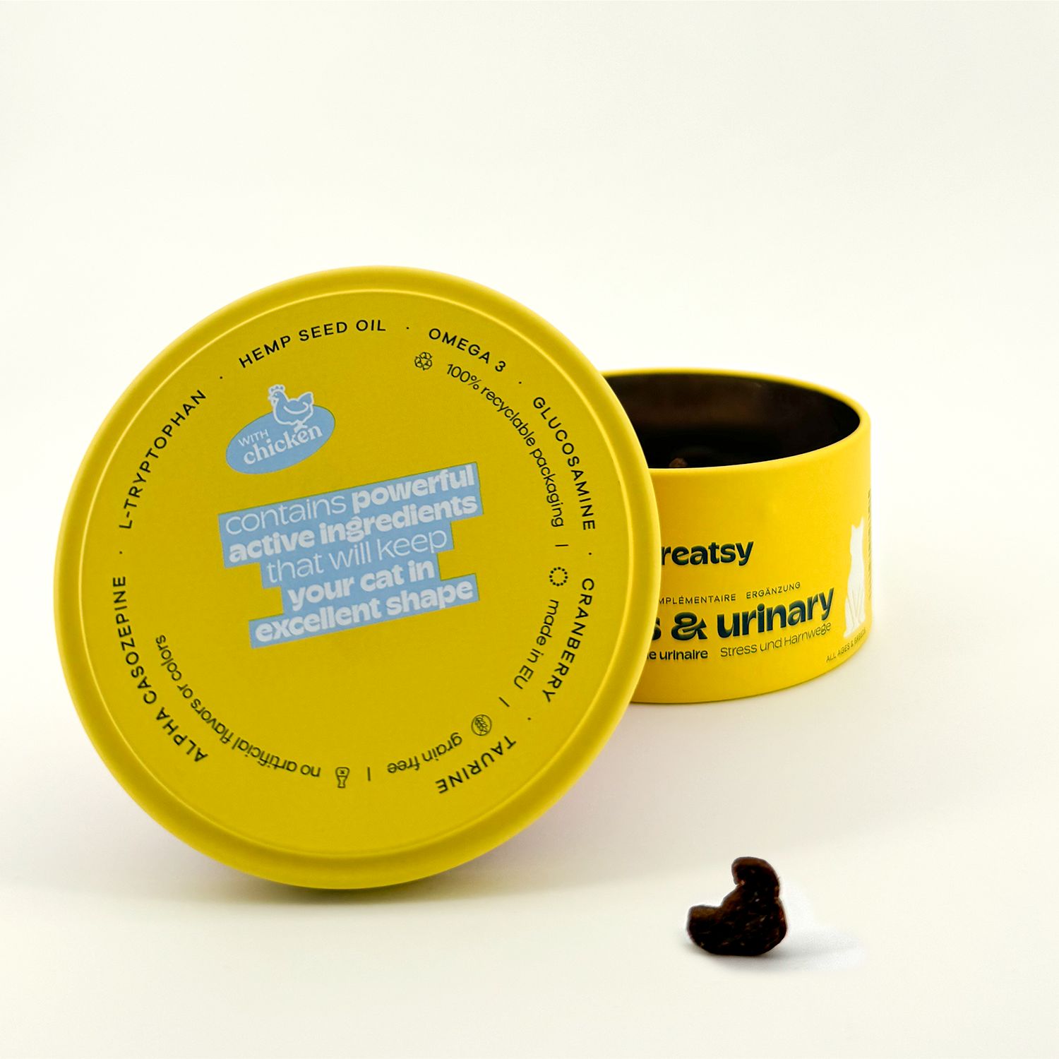 Gelber Deckel mit Text. Dose mit "treatsy stress & urinary". Ein brauner Snack.