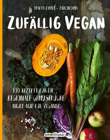 Buchcover mit Titel "Zufällig Vegan" und Gemüse-Arrangement. Autor: Marta Dymek. Verlag: smarticular.