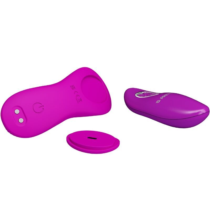 Lila Vibrator, Fernbedienung und ein separates rundes Teil. Der Vibrator hat ein Wellenmuster.