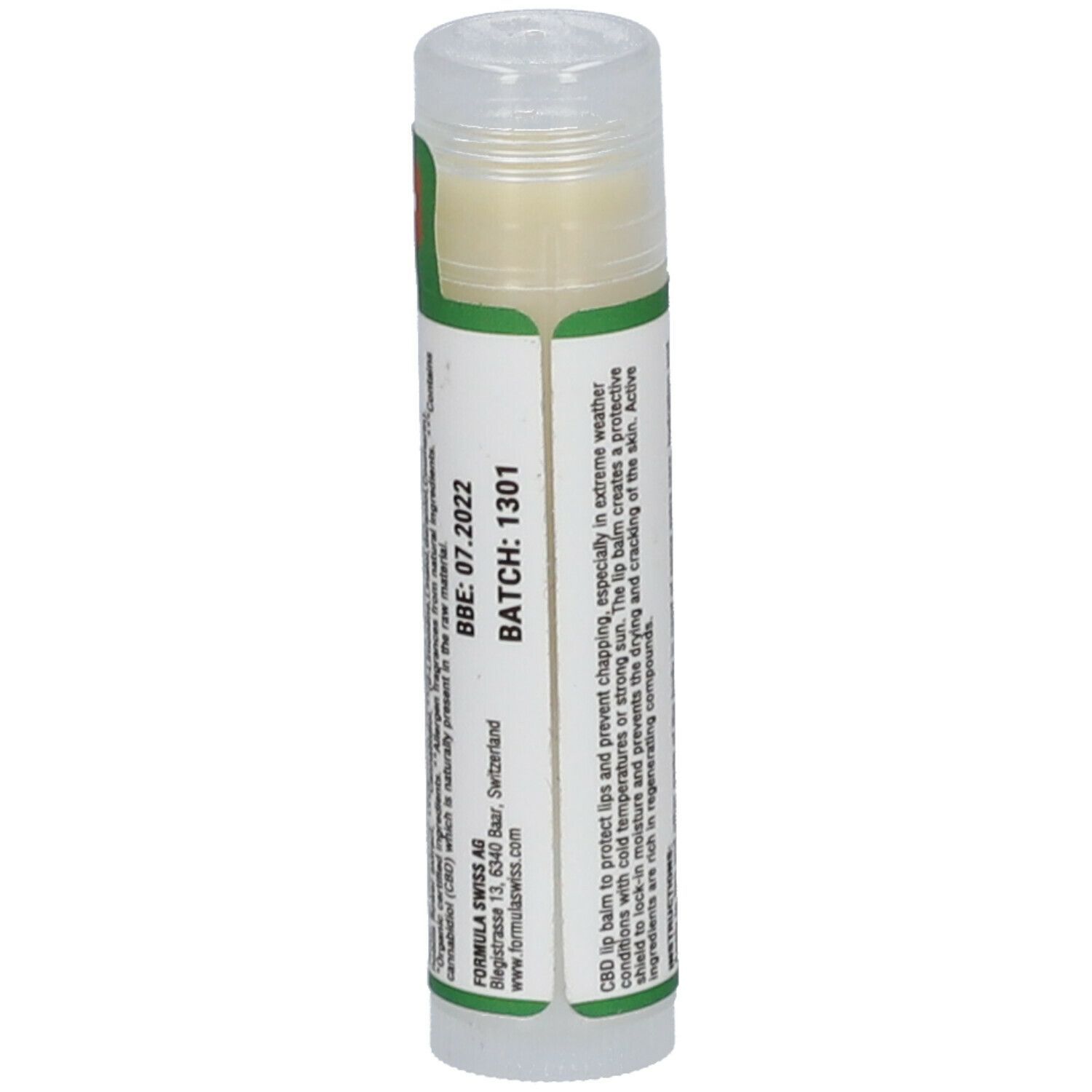 Lippenbalsam-Stift. Grüner Aufkleber mit Text, Batch-Nummer und Verfallsdatum. Transparenter Deckel.
