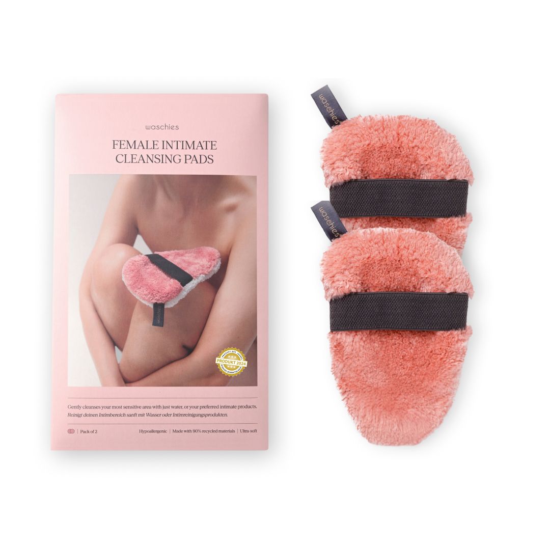 Verpackung mit zwei rosa Intimwaschpads. Text: Female Intimate Cleansing Pads. Waschies. Mit Illustration einer Frau.
