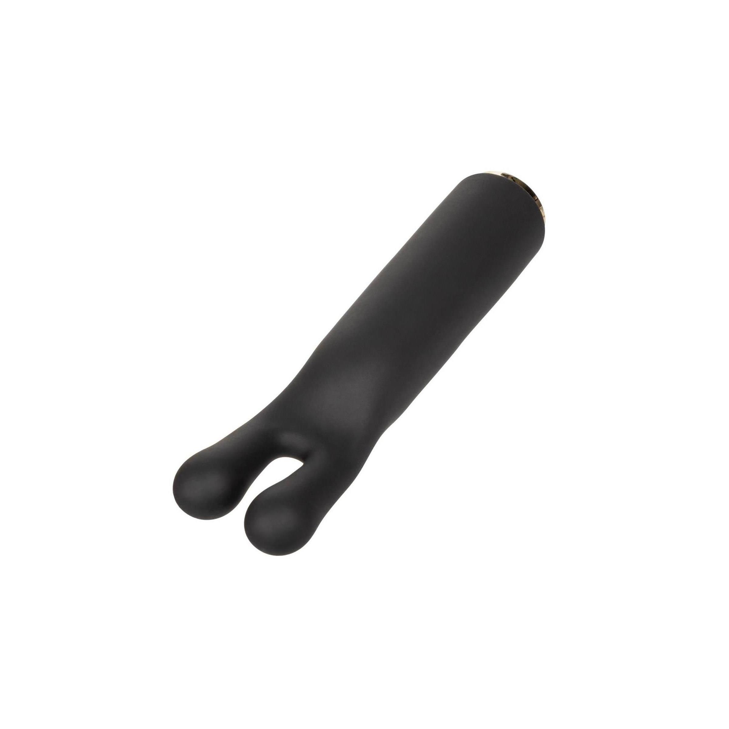 Schwarzes Wellness-Produkt mit zwei abgerundeten Enden. Zylindrische Form, goldfarbener Abschluss.