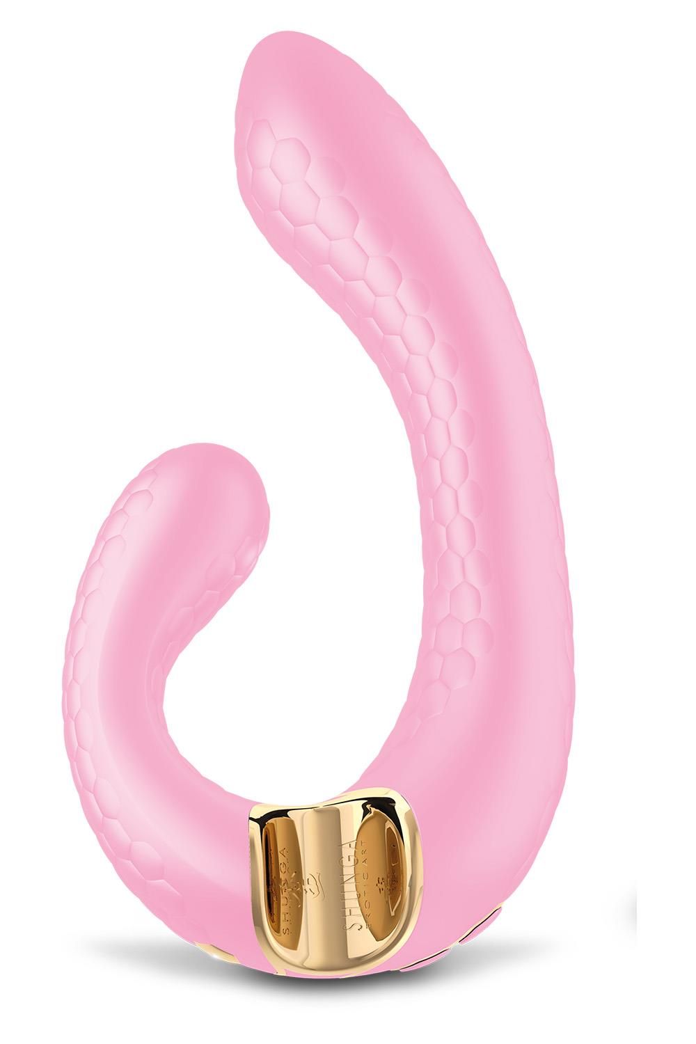 Rosa Massagegerät mit goldfarbenem Akzent. Die Oberfläche hat ein wabenförmiges Muster.