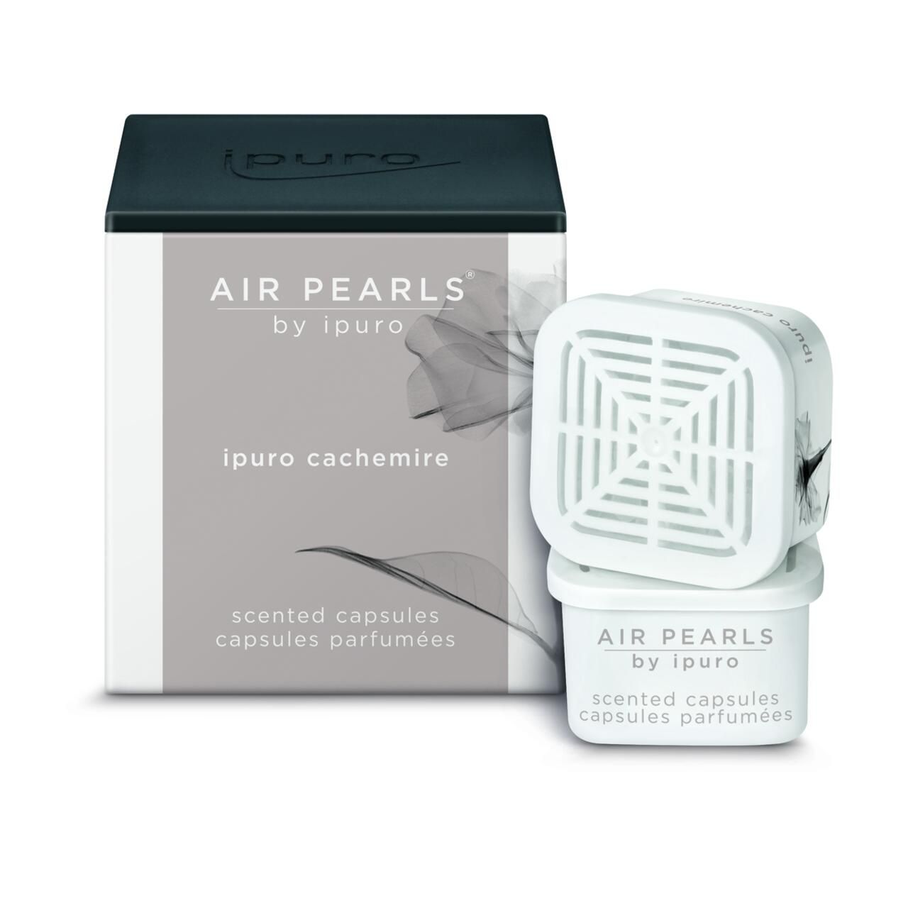 Verpackung und Kapseln. Auf der Verpackung: "AIR PEARLS by ipuro", "ipuro cachemire", "scented capsules". Weiße Kapseln.