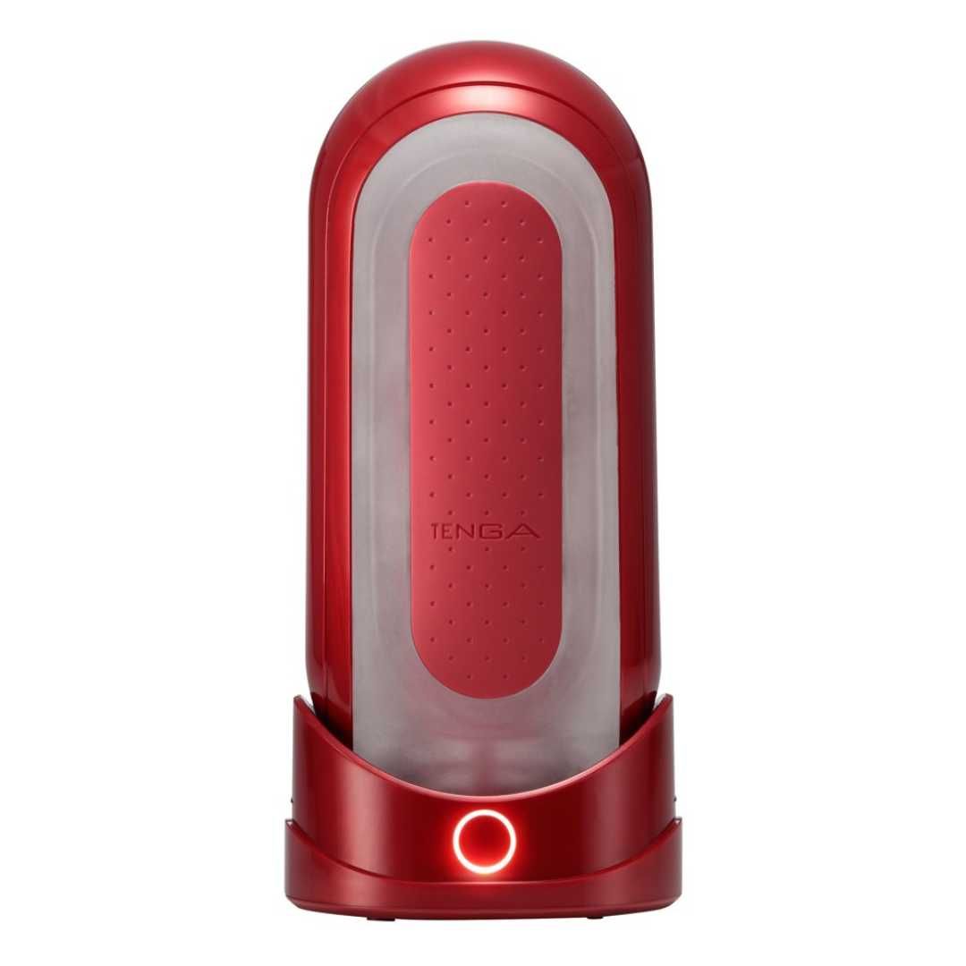 Rotes, längliches Wellness-Produkt mit weißem Innenraum. Der Name TENGA ist sichtbar. Beleuchteter Knopf.