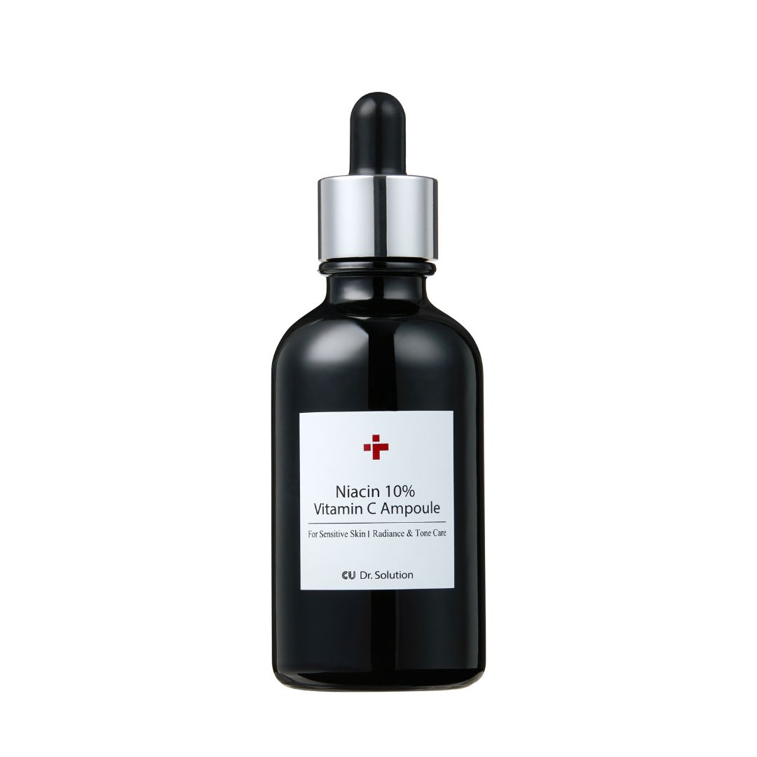 Schwarze Glasflasche mit Pipette. Etikett mit rotem Kreuz und Text: Niacin 10% Vitamin C Ampulle. Für empfindliche Haut.