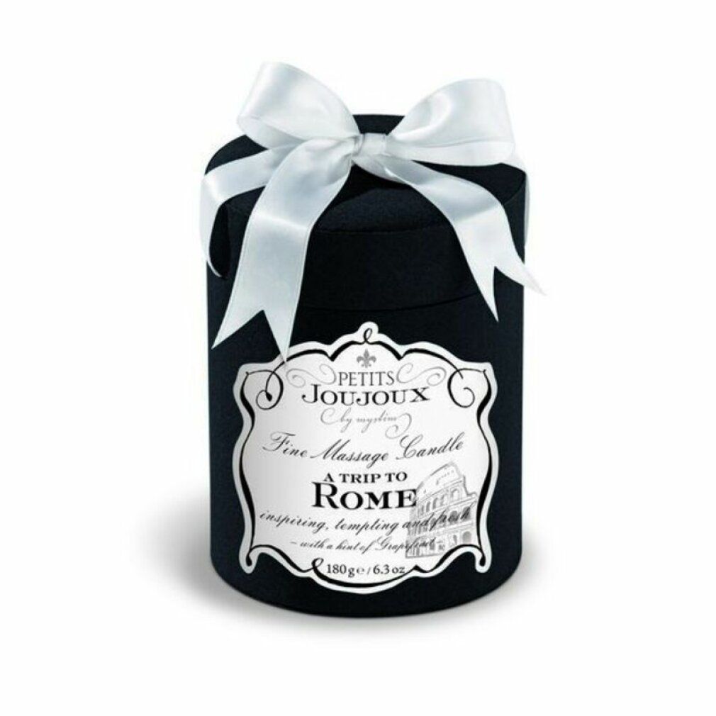 Zylindrische schwarze Verpackung mit weißer Schleife. Aufschrift: A Trip to Rome, Fine Massage Candle.