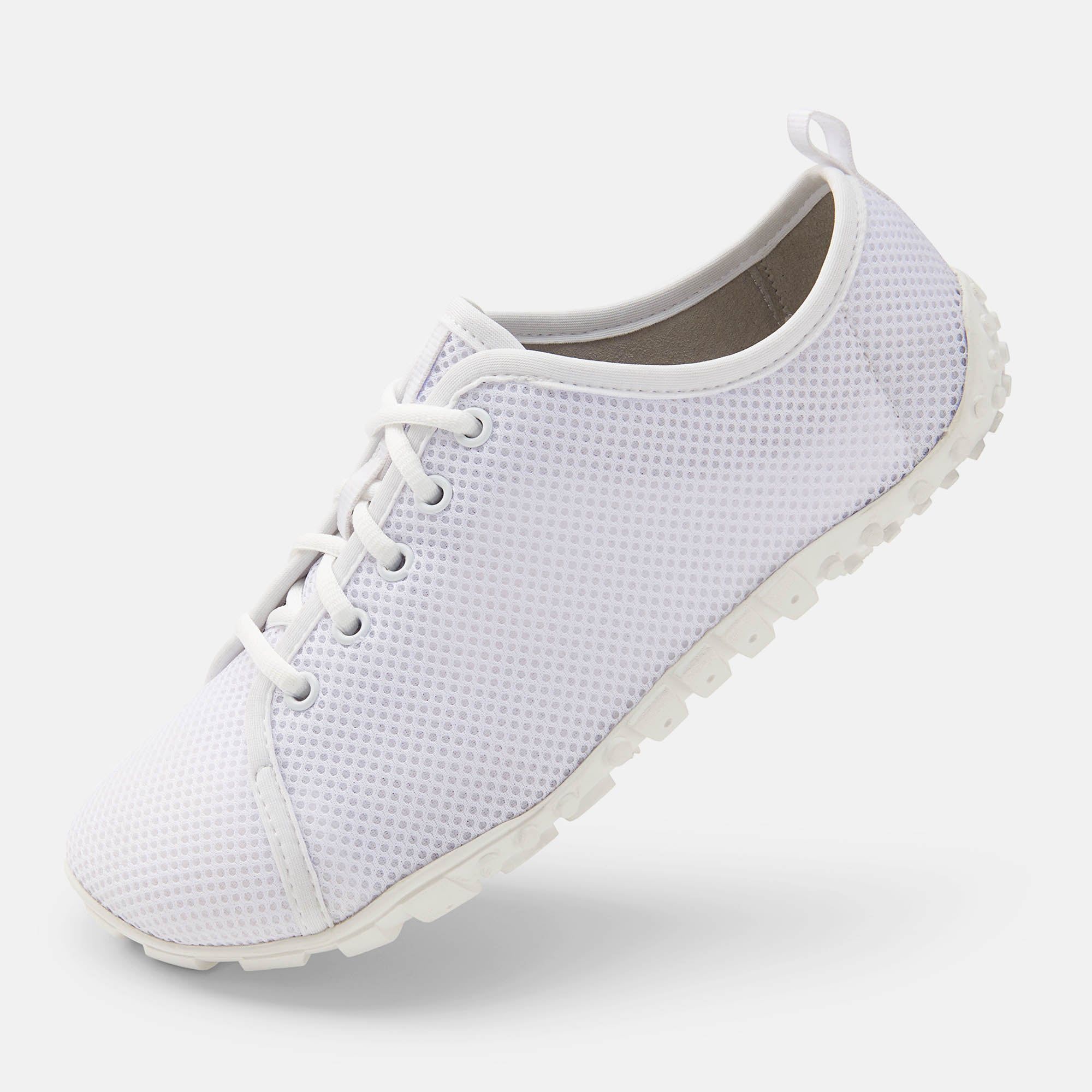 Weißer Schnürschuh. Mesh-Obermaterial, breite Passform. Gummisohle. Schuh von der Seite.