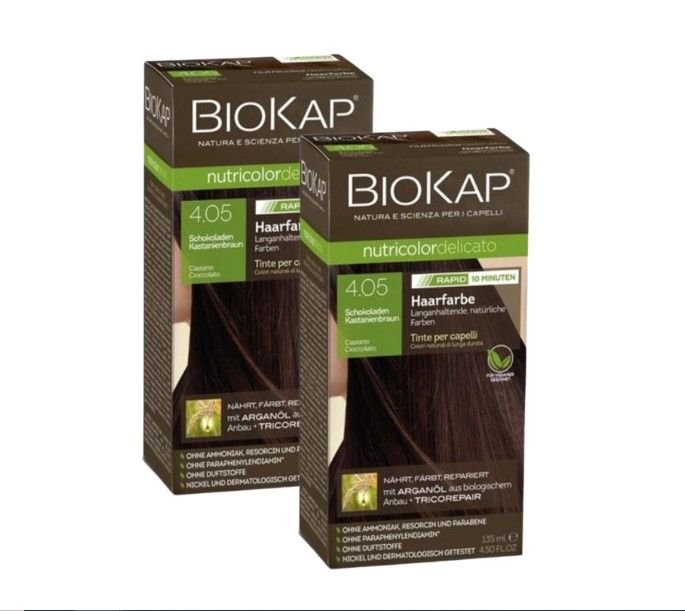 Zwei Schachteln Haarfarbe von Biokap. Aufschrift: 4.05 Schokoladen Kastanienbraun. Grün-braune Verpackung mit Produktinformationen.